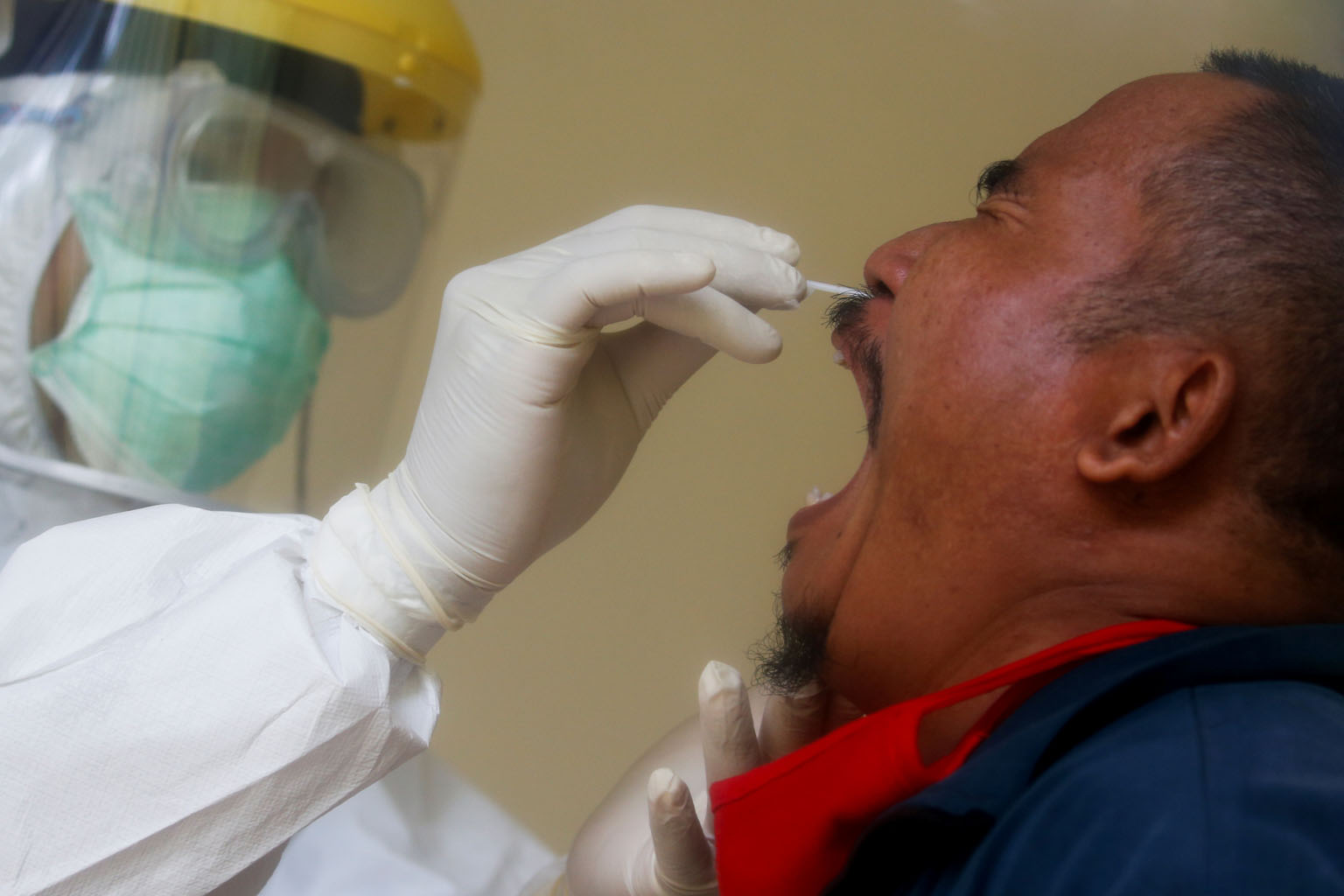 An Indonesian man getting a nasal swab. Indonesia has reported 12,776 cases and 930 deaths from the highly contagious Covid-19.
