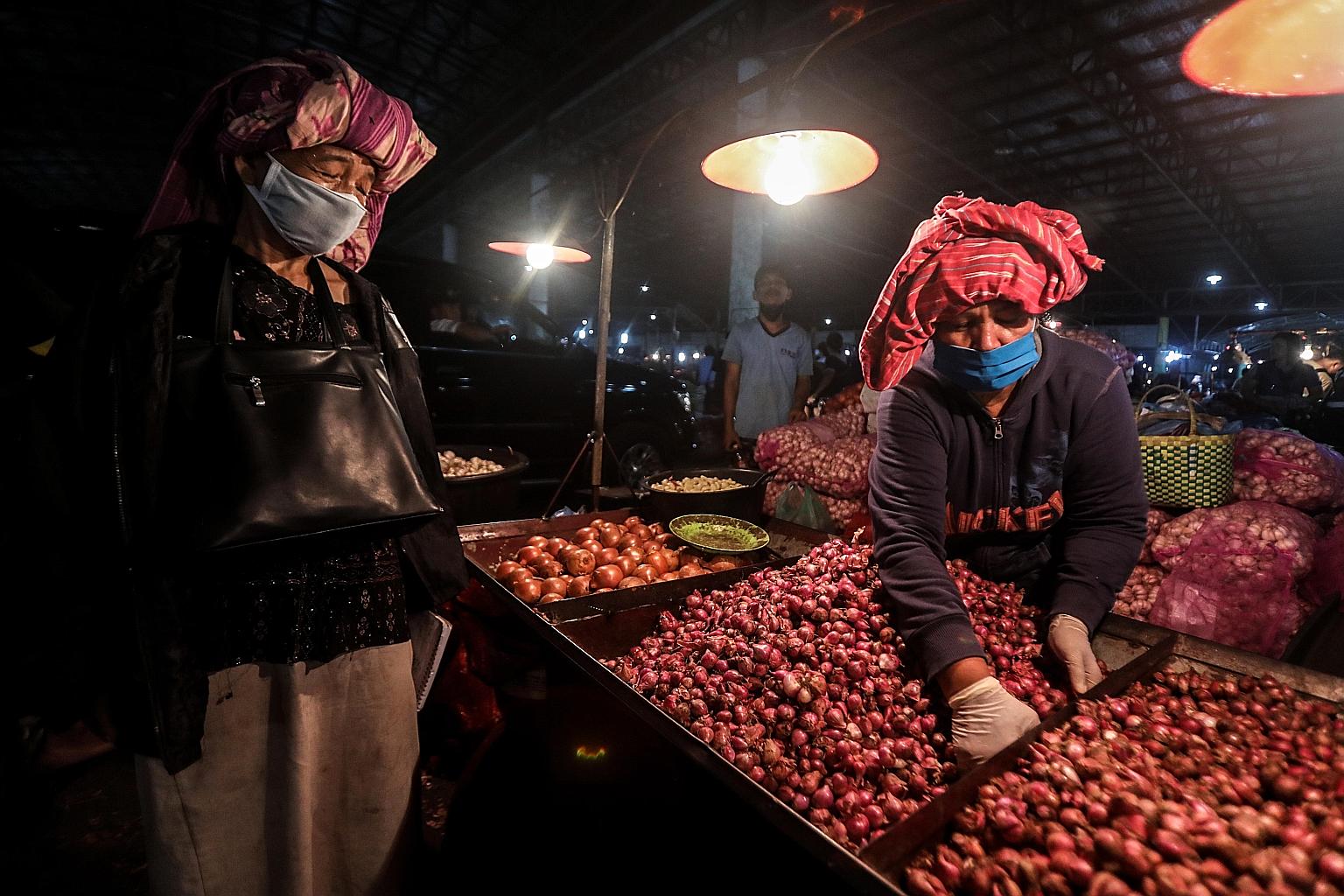 A vegetable vendor in a market in Medan, North Sumatra. The pandemic has made Indonesia aware of the fragility of its food system, with national dependence on a single staple, and heavily imported food items.