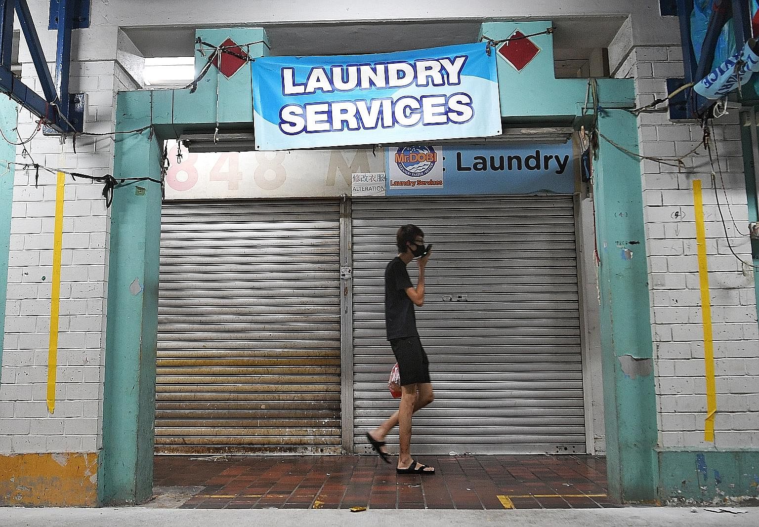 Mr Dobi Laundry Services in Yishun is one of the laundry shops that may not reopen yet, while some shops are planning to resume business with shorter opening hours and others are saying they will not allow walk-in customers. ST PHOTO: KHALID BABA