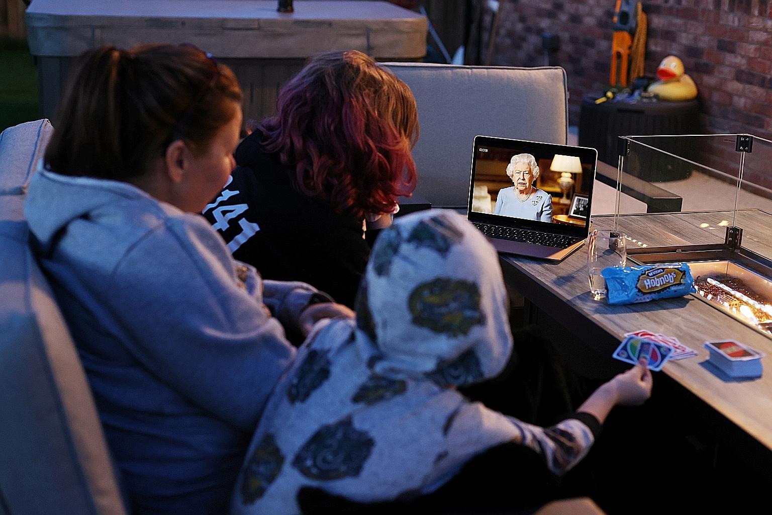 A family in Britain watching Queen Elizabeth II making her televised address to the nation on Friday, at the same time that her father, King George VI, gave a radio address marking VE Day in 1945. "Never give up, never despair - that was the message