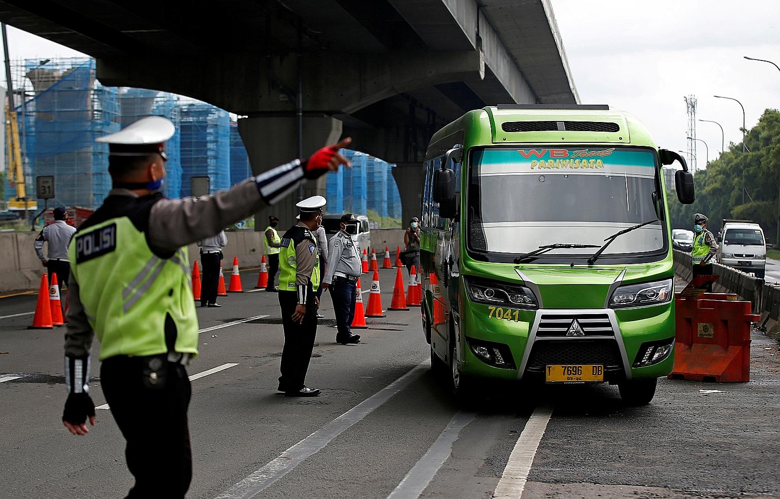 Indonesian police at a highway checkpoint in Bekasi on the outskirts of Jakarta on April 24. That day, the government started its ban on people travelling home for Hari Raya Idul Fitri in a bid to curb the spread of Covid-19.