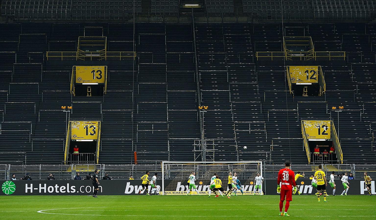 Borussia Dortmund taking on Wolfsburg in front of empty stands in 2017 due to a one-match ban for Dortmund fans. The Signal Iduna Park is set to be closed to fans when Dortmund take on derby rivals Schalke when the Bundesliga restarts on Saturday. 