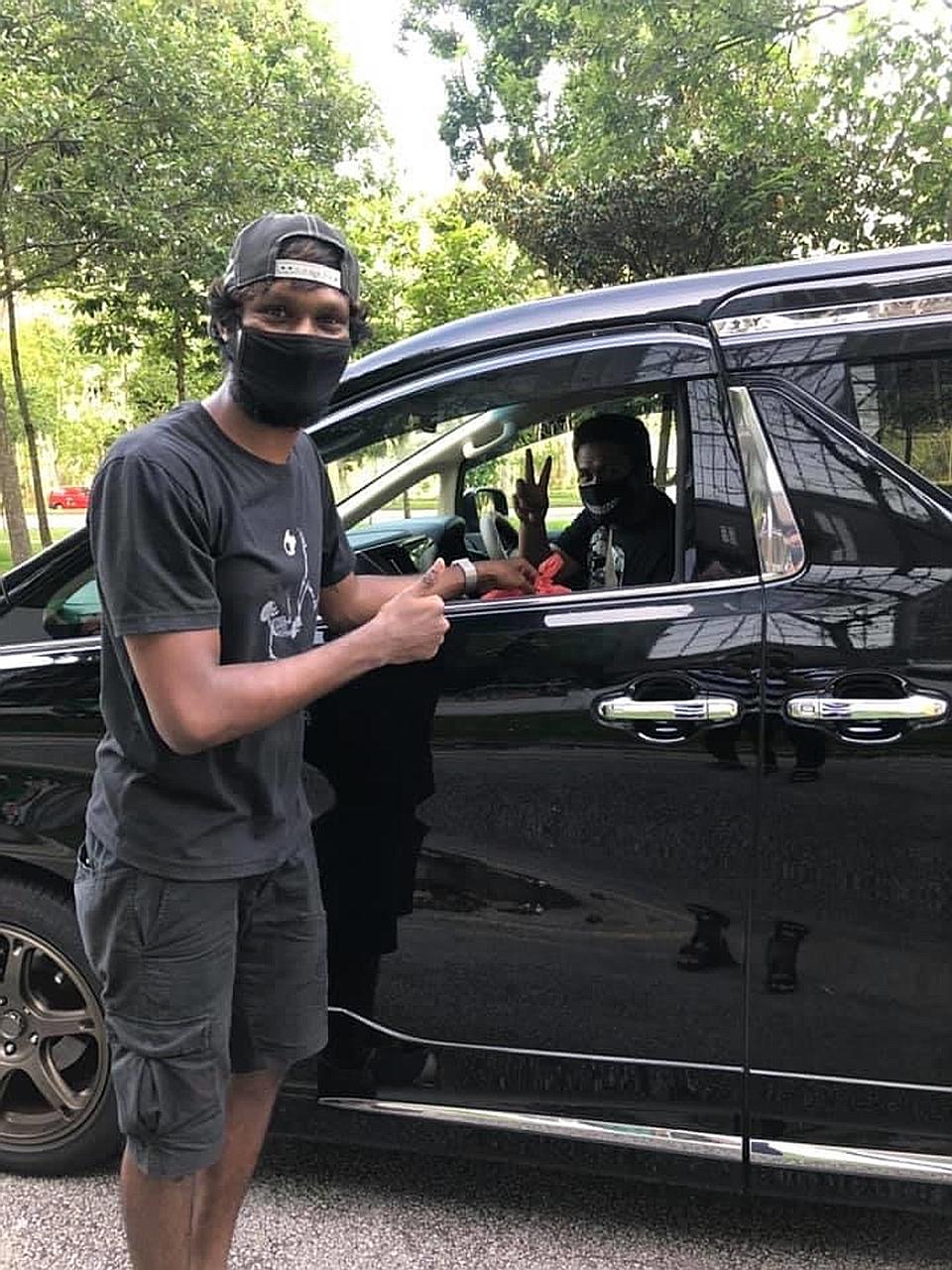 Tampines defender Madhu Mohana (left) was among several footballers who helped raise funds for the briyani giveaway in Woodlands on Friday.