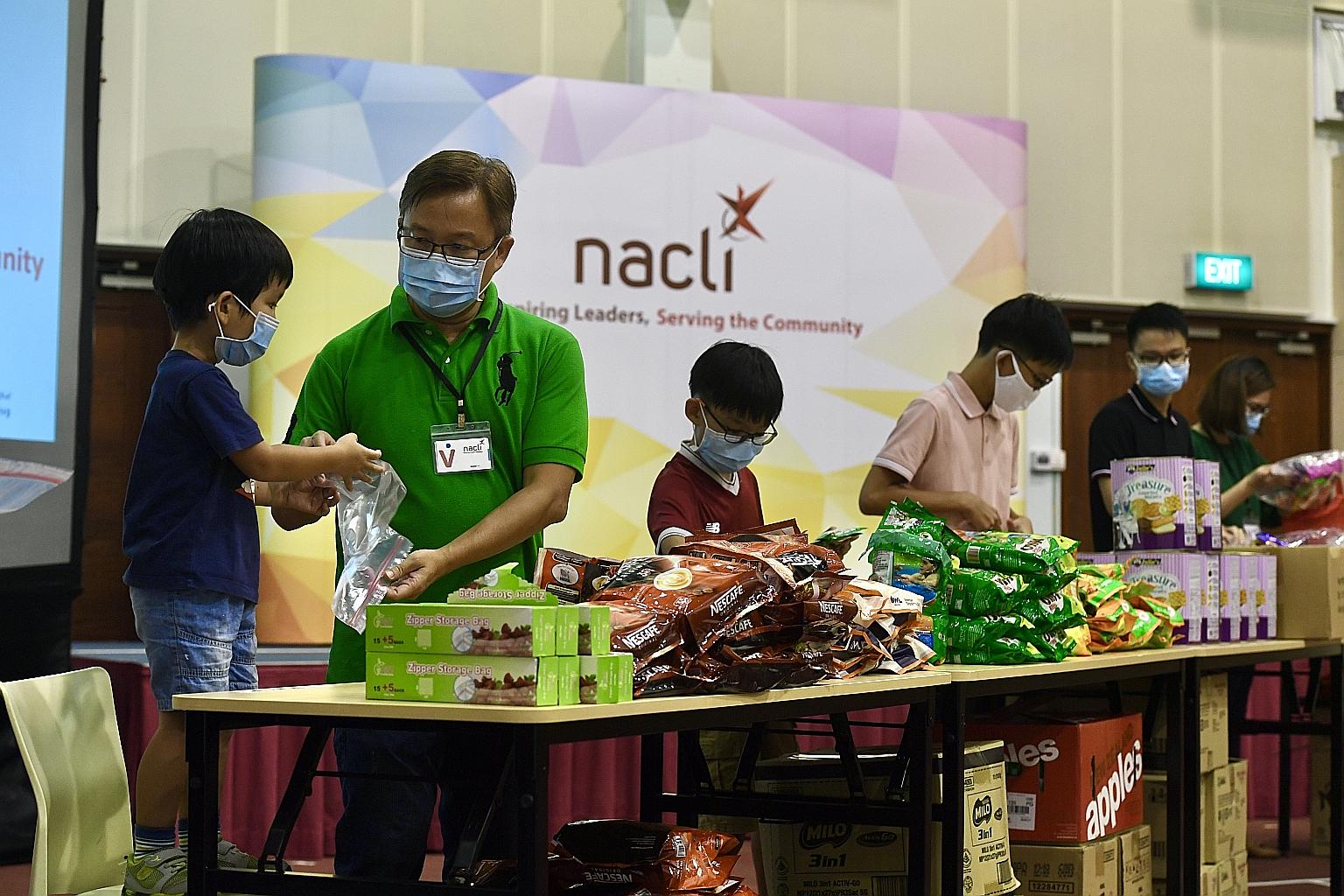 Singaporean Joshua Koh, 47, packing items with his youngest son Joash (far left), three, alongside sons Jireh, 10; Jakin, 13; and Jedidah, 17; and his wife Mrs Koh, 44, last month at the National Community Leadership Institute (Nacli) in South Buona 
