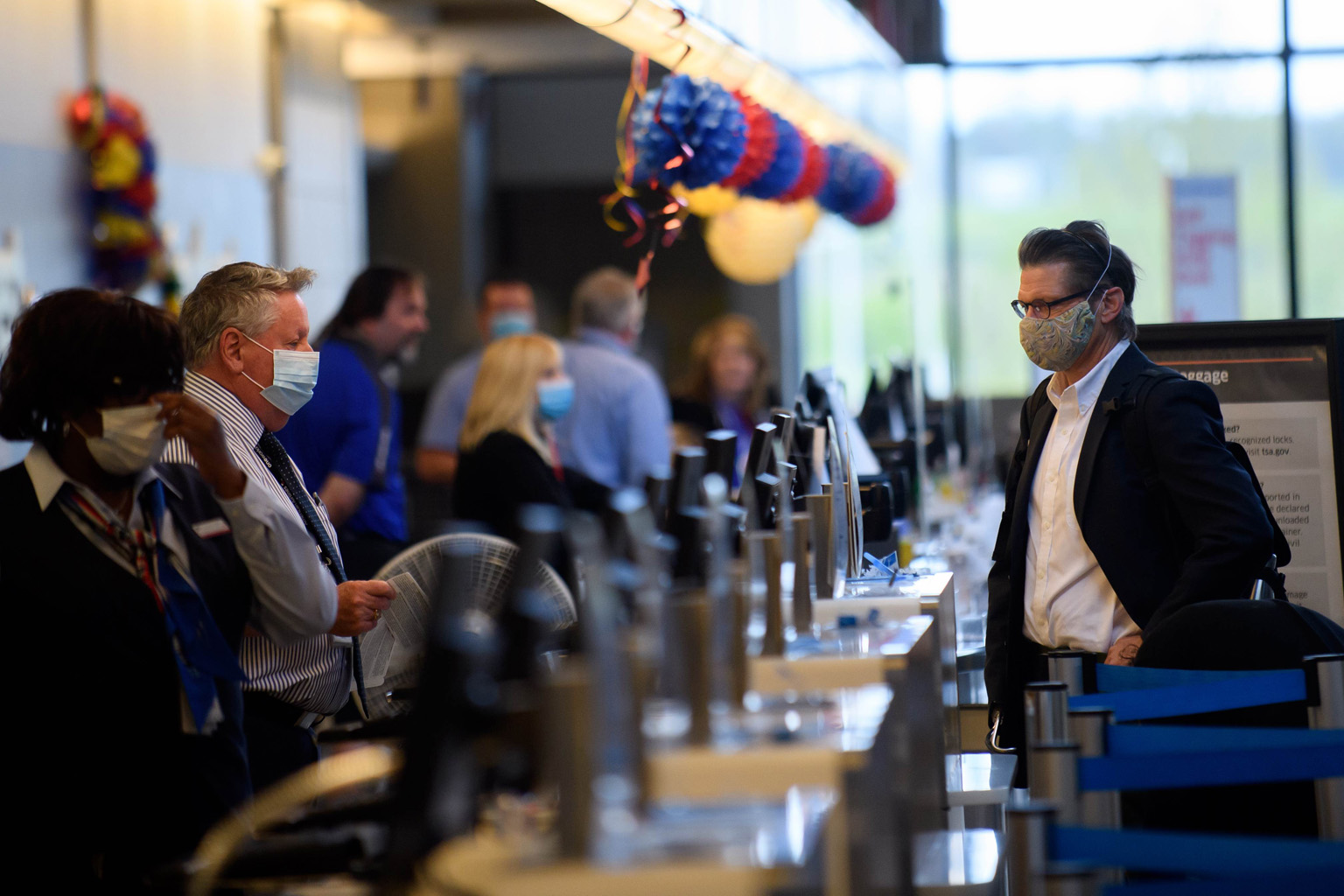 A traveller at a counter at Pittsburgh International Airport in the US state of Pennsylvania. Airlines for America, which represents the largest US airlines, said on Saturday that temperature checks "will add an extra layer of protection for passenge