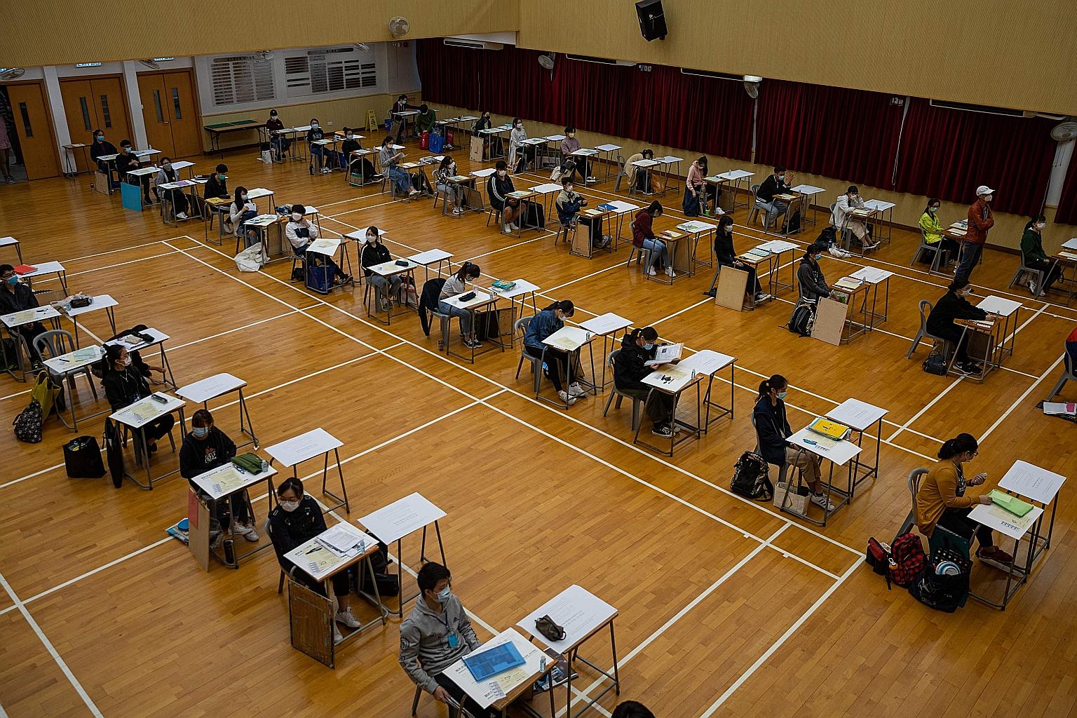 Hong Kong students - masked and seated apart - taking the Diploma of Secondary Education university entrance exams last month. Liberal studies, one of four compulsory subjects at senior secondary school level, has been blamed for radicalising the cit