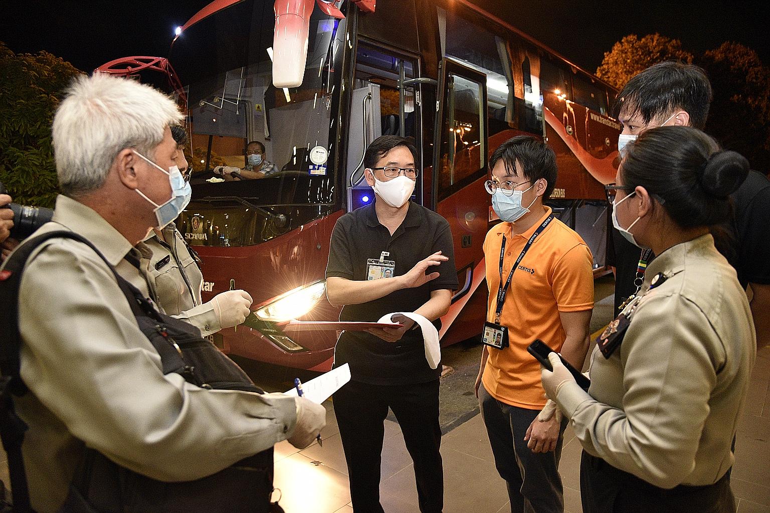 Mr Bernard Lim (right), senior director of the Ministry of Transport's international relations and security division, speaking to his team outside the Terminal 3 coach area on Sunday.