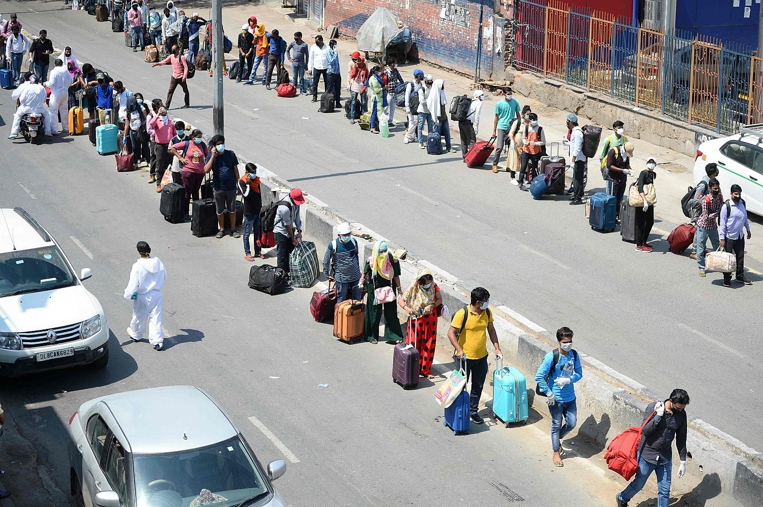 People queueing to enter a railway station in New Delhi on Tuesday, as trains started running again after India began a gradual lifting of its stringent lockdown against the spread of the coronavirus.