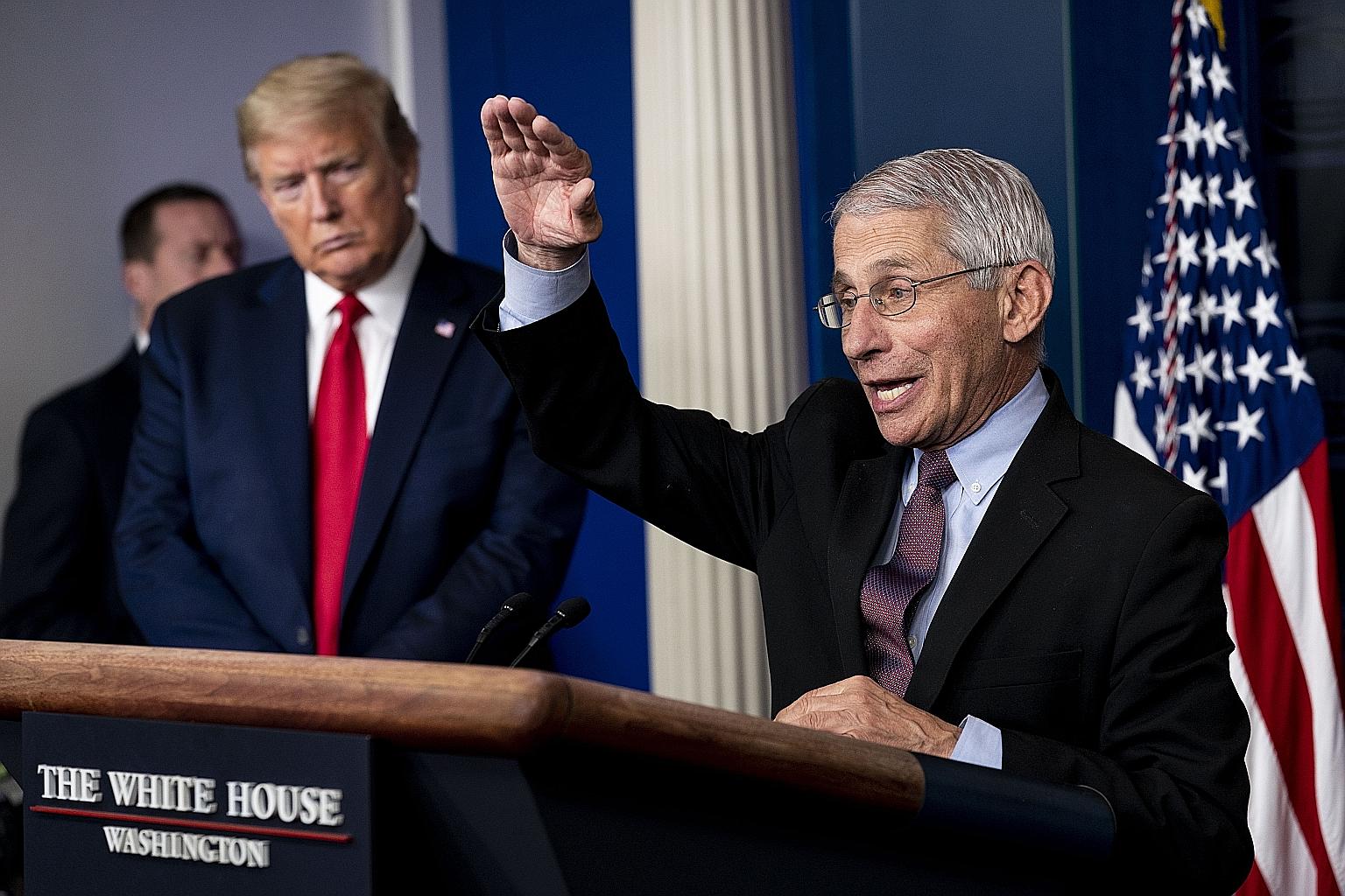 National Institute of Allergy and Infectious Diseases director Anthony Fauci at a White House coronavirus task force briefing last month with US President Donald Trump. Dr Fauci has made statements that are at odds with Mr Trump's. PHOTO: NYTIMES