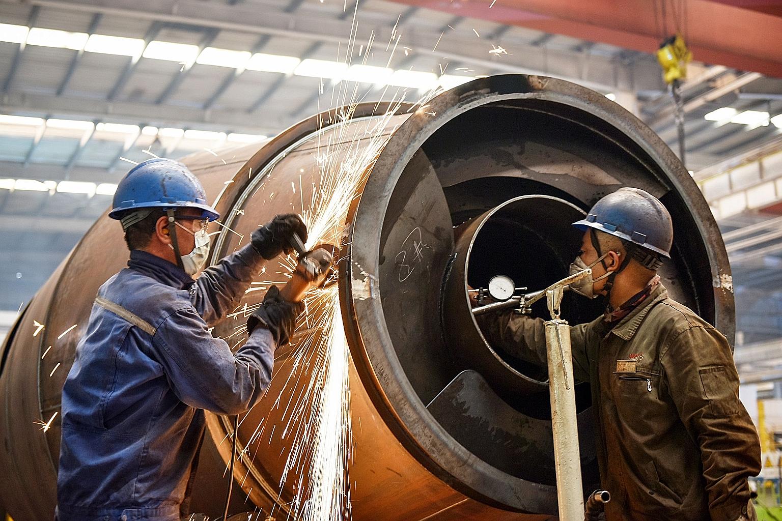 Work in progress on a truck production line at a factory in Zhangjiakou in China's northern Hebei province earlier this week. The production of oil, coal, metals and electricity all increased as plants restarted operations last month. But the country
