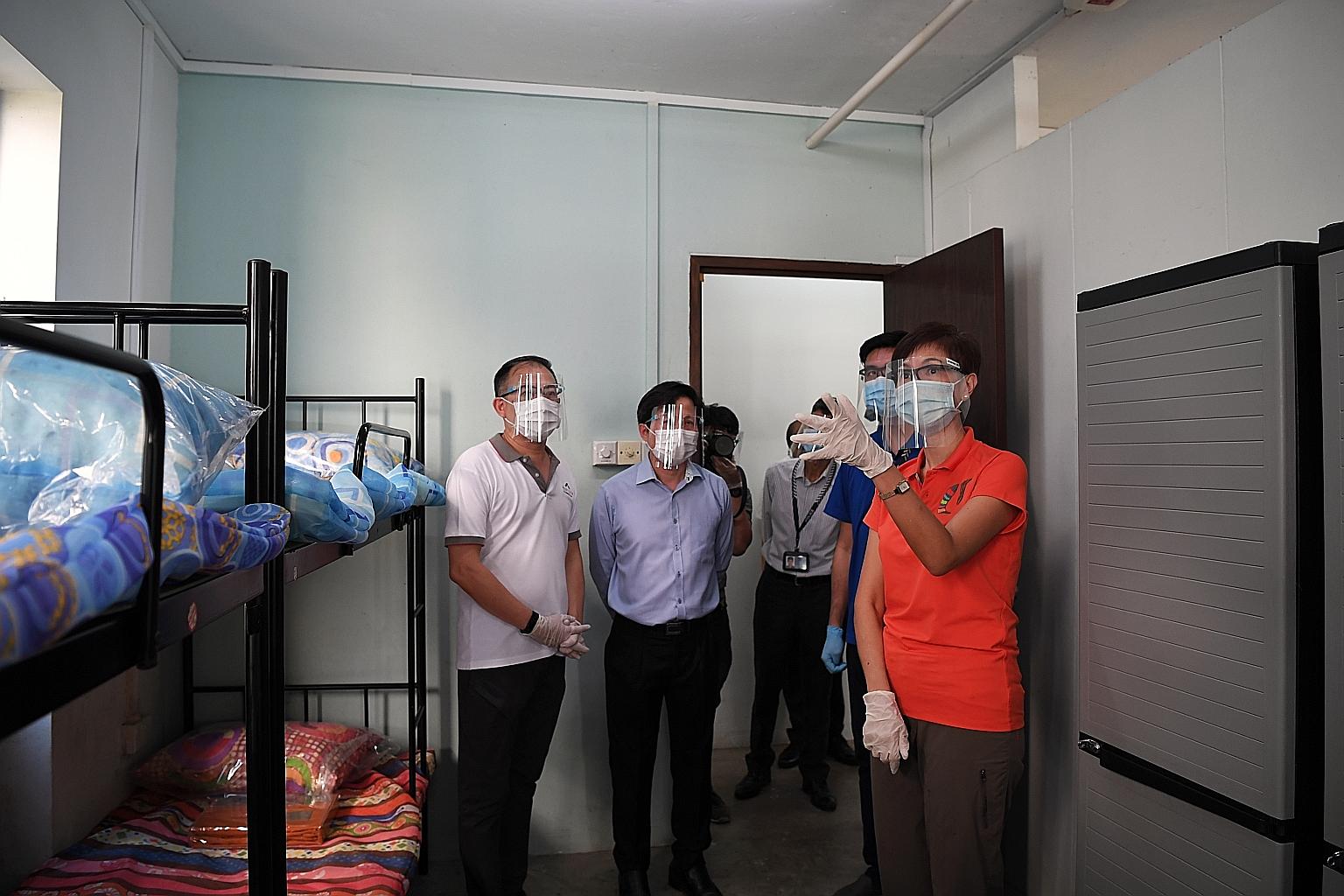 Manpower Minister Josephine Teo visiting Westlite Papan dormitory yesterday to view rooms that have been designated for recovered workers. She also visited Avery Lodge dormitory to tour the on-site medical facilities such as a medical post, swab isol