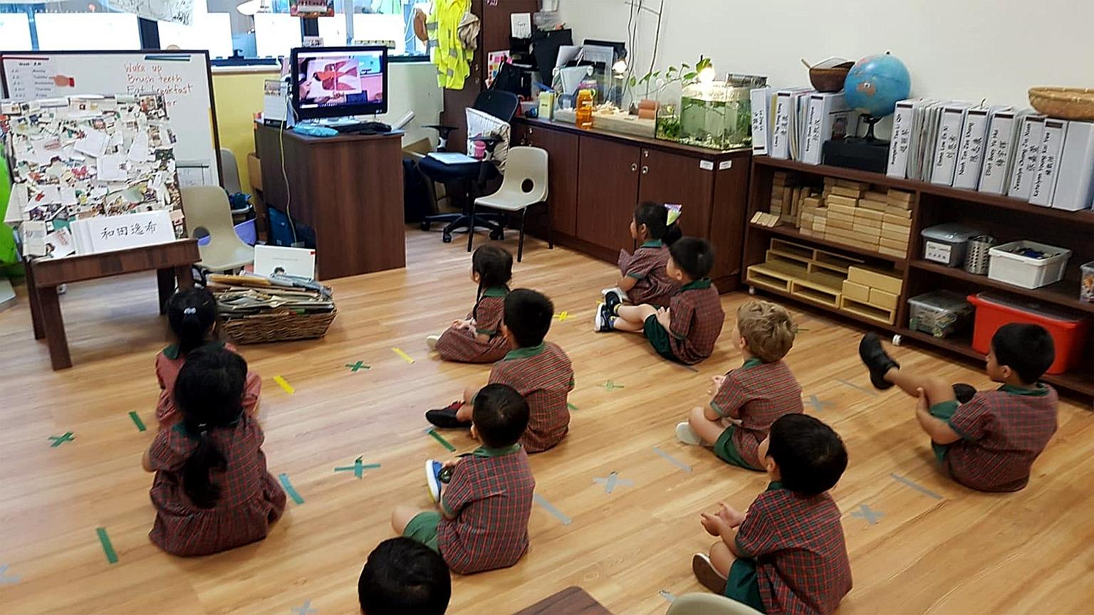 Children preparing for home-based learning, while sitting 1m apart, at an EtonHouse Pre-School in Mountbatten Road before the circuit breaker.