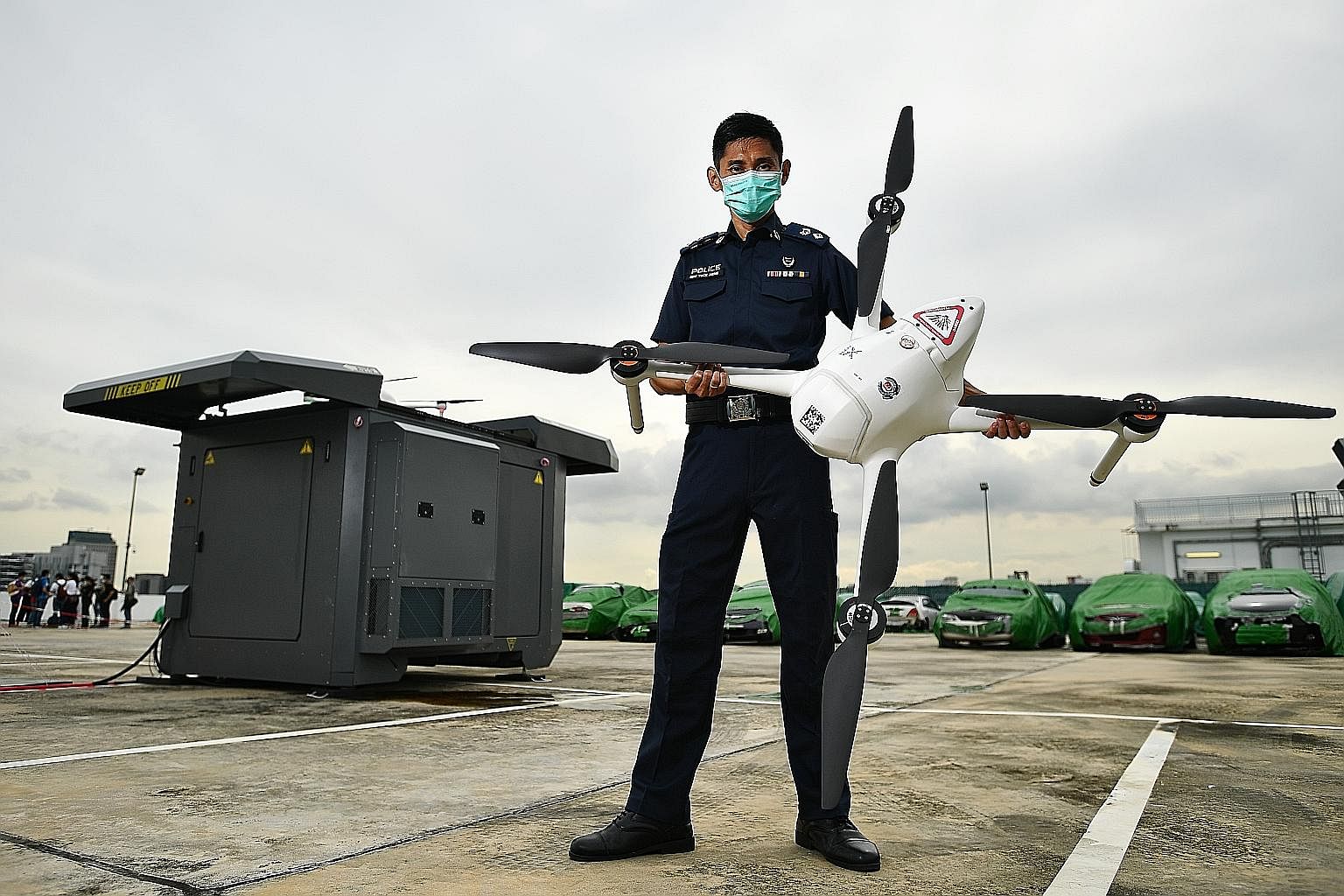 Deputy Superintendent of Police Sum Teck Meng, who is in charge of the Home Team Unmanned Aerial Vehicles unit, with the drone and drone box last Wednesday. Two such drone boxes are on trial and each drone is about 1.79m wide and weighs about 10kg. H