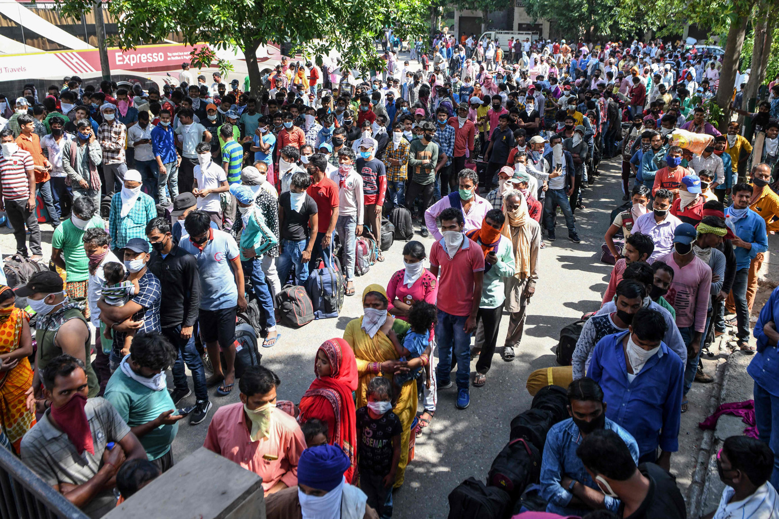 Stranded migrant workers and their families waiting to be thermally screened before taking a train from Amritsar to their hometowns in Bihar state yesterday. The movement of millions of migrant workers from the cities where they had jobs to their hom