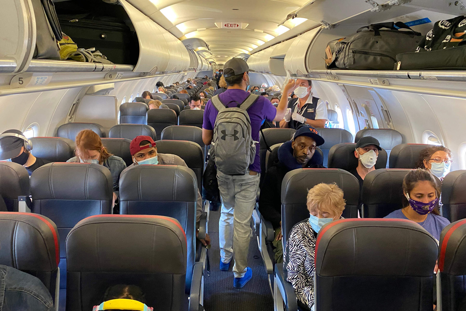 Passengers, almost all wearing masks, on board an American Airlines flight from New York City to North Carolina on May 3. The wearing of masks to protect against the coronavirus has become such a sensitive issue in the US that airlines are struggling