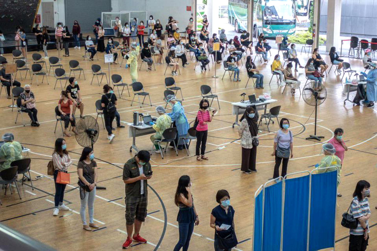 Pre-school employees yesterday at Temasek Polytechnic, one of the centres conducting the one-time swab tests.
