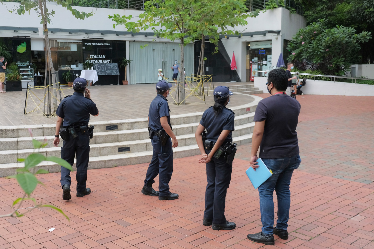 Police (above) patrolling in the Robertson Quay area yesterday. The URA ban on alcohol takeaways came after a Facebook post showing photos of people failing to stay at least 1m from one another on Saturday (left) in the waterfront area went viral.