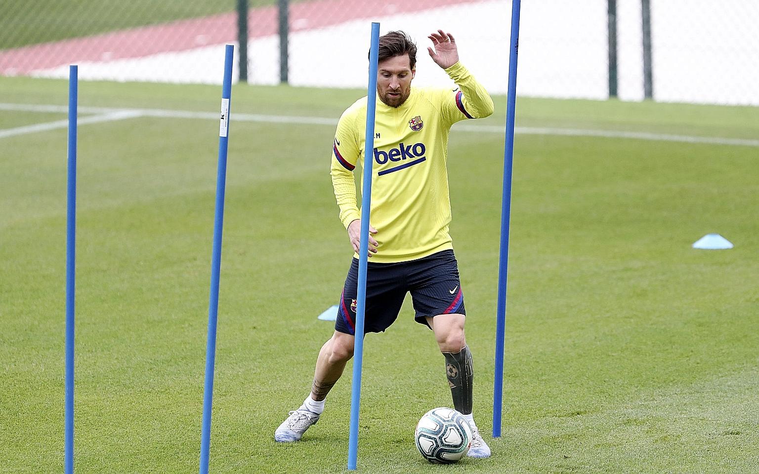 Barcelona's Argentina star Lionel Messi dribbling during training on May 9. Footballers in Spain could work out in groups of 10 from yesterday. PHOTO: AGENCE FRANCE-PRESSE
