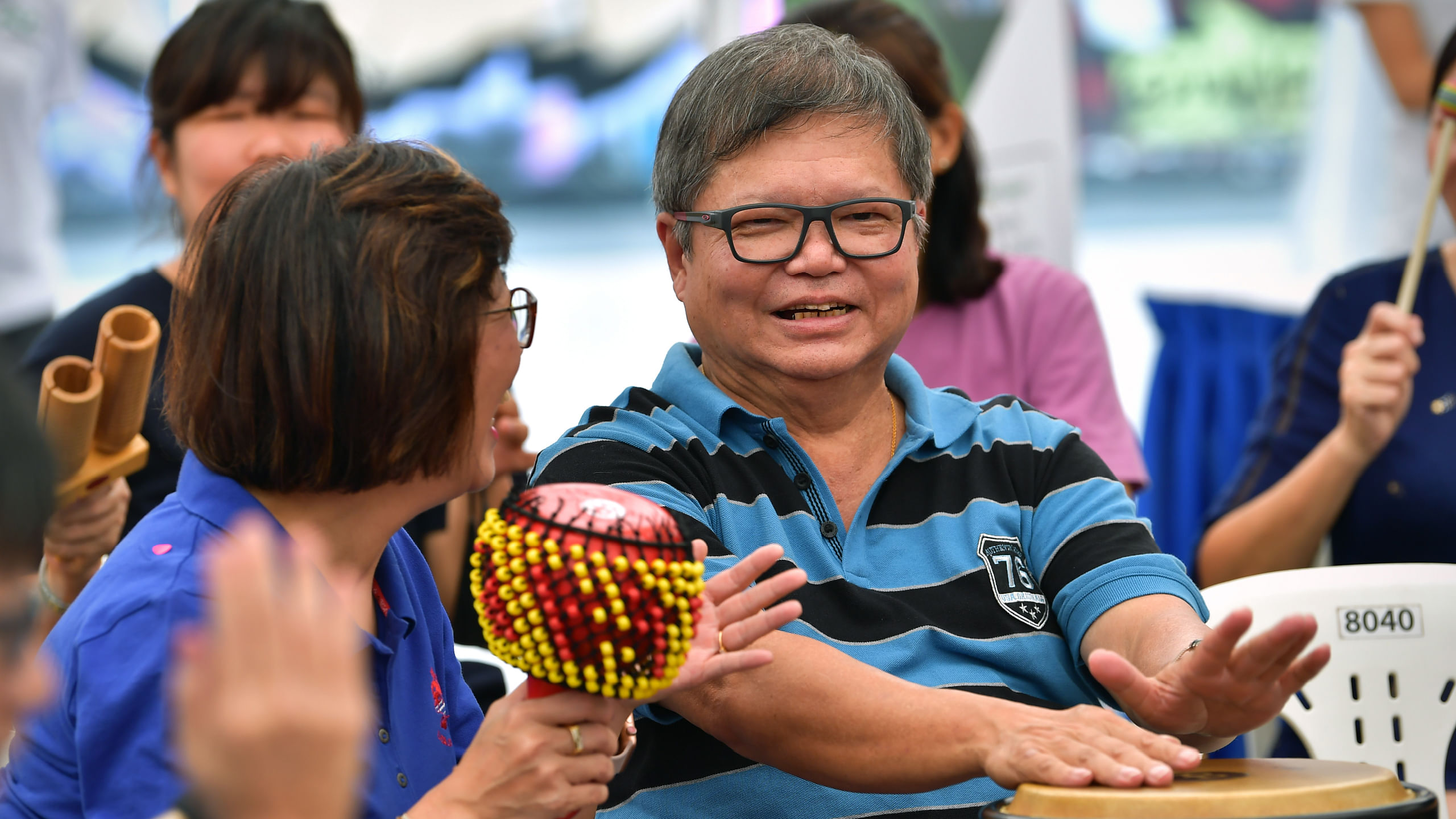 Lai Quen and Steven shares a joke during a drumming session with other PWDs, their caregivers and members of the public at *SCAPE Singapore on World's Alzheimer's Day on Sept 21, 2019.