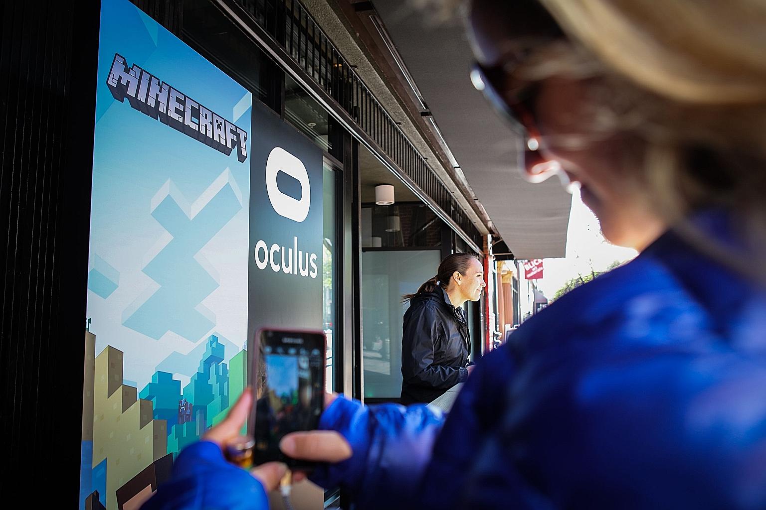 A guest taking a photo of the signs at the entrance of the Minecraft for Gear VR press demonstration and reception in San Francisco in this 2016 file photo.