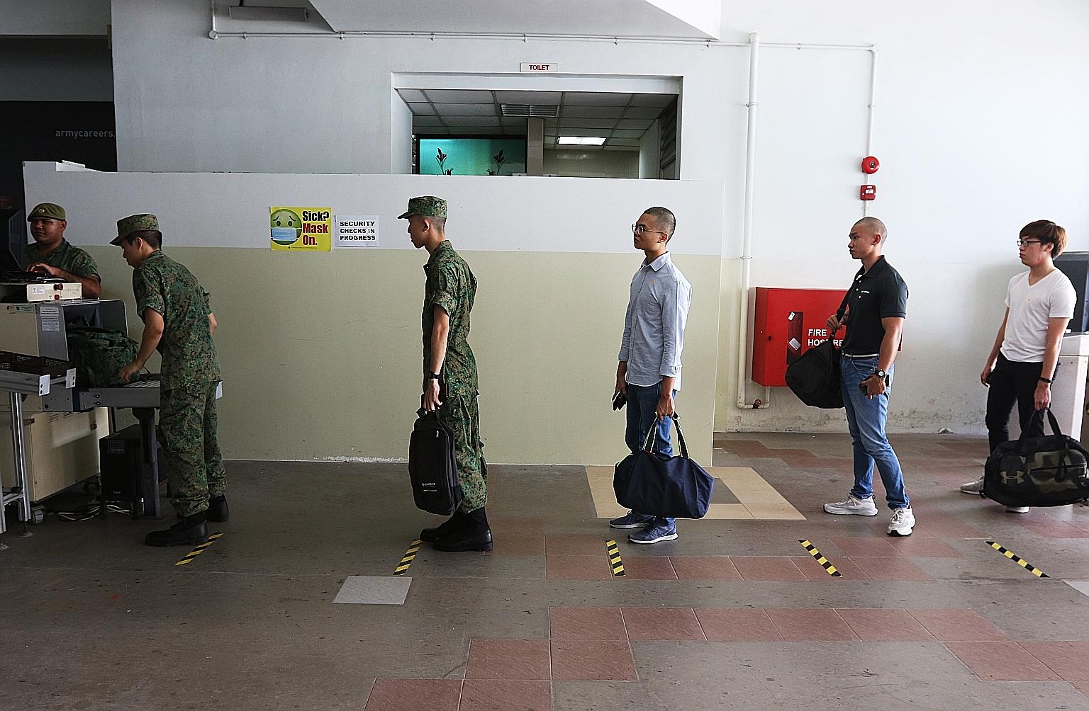 Recruits on their day of enlistment at the SAF Ferry Terminal on April 1. The resumption of basic military training is necessary to generate operational units as well as select commanders for training at the Officer Cadet and Specialist Cadet schools