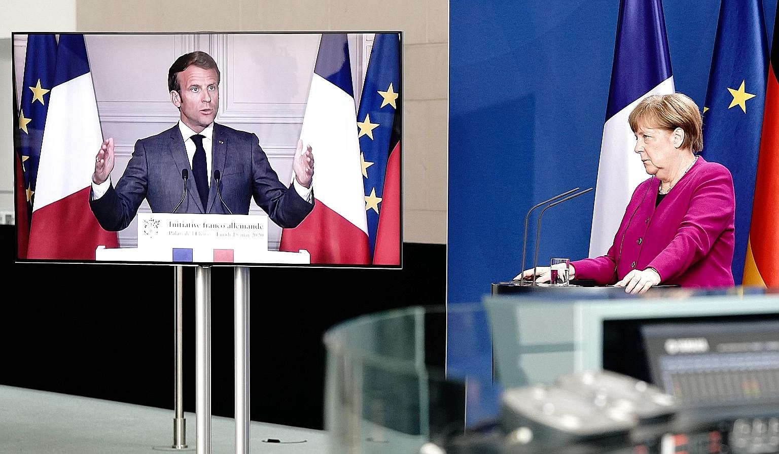 French President Emmanuel Macron and German Chancellor Angela Merkel at their joint video news conference on Monday, during which they supported the idea of creating a €500 billion (S$775 billion) bond designed to assist countries and industries se