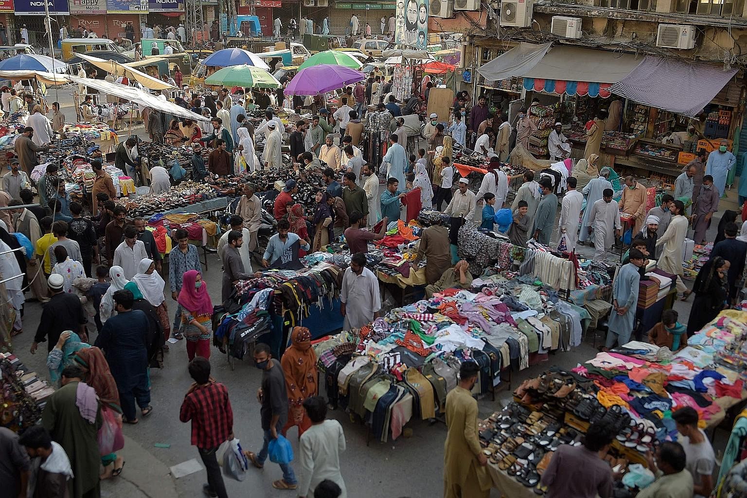 A market in Raja Bazaar in the Pakistani city of Rawalpindi on Tuesday. In Pakistan, malls and markets have reopened along with mosques - in contrast with India where a lockdown remains in place. PHOTO: AGENCE FRANCE-PRESSE