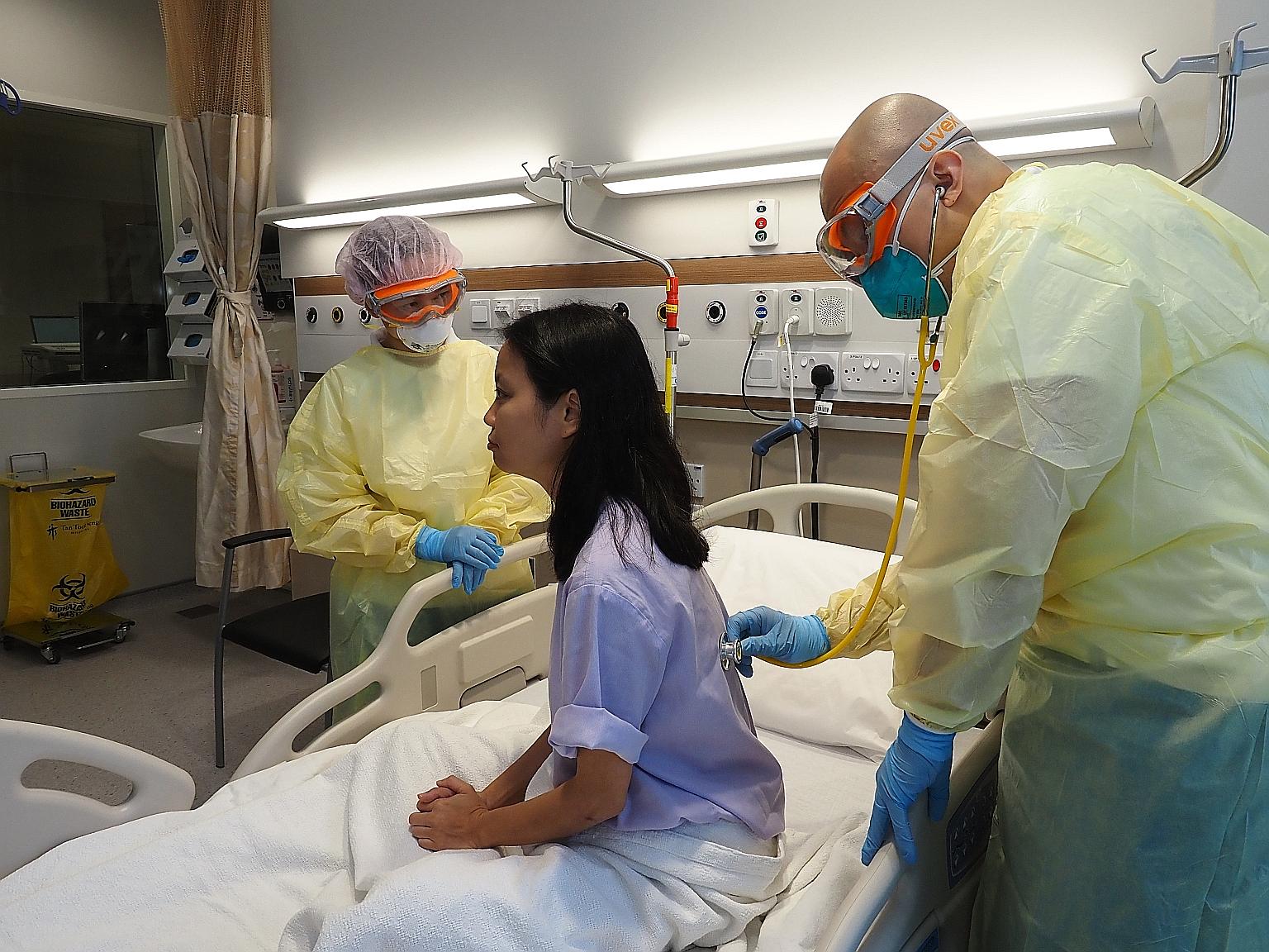 A National Centre for Infectious Diseases doctor listening to the lungs of a patient as part of the treatment for Covid-19. To deal with the disease decisively, there is an urgent need for a vaccine to immunise enough people in the population to prev