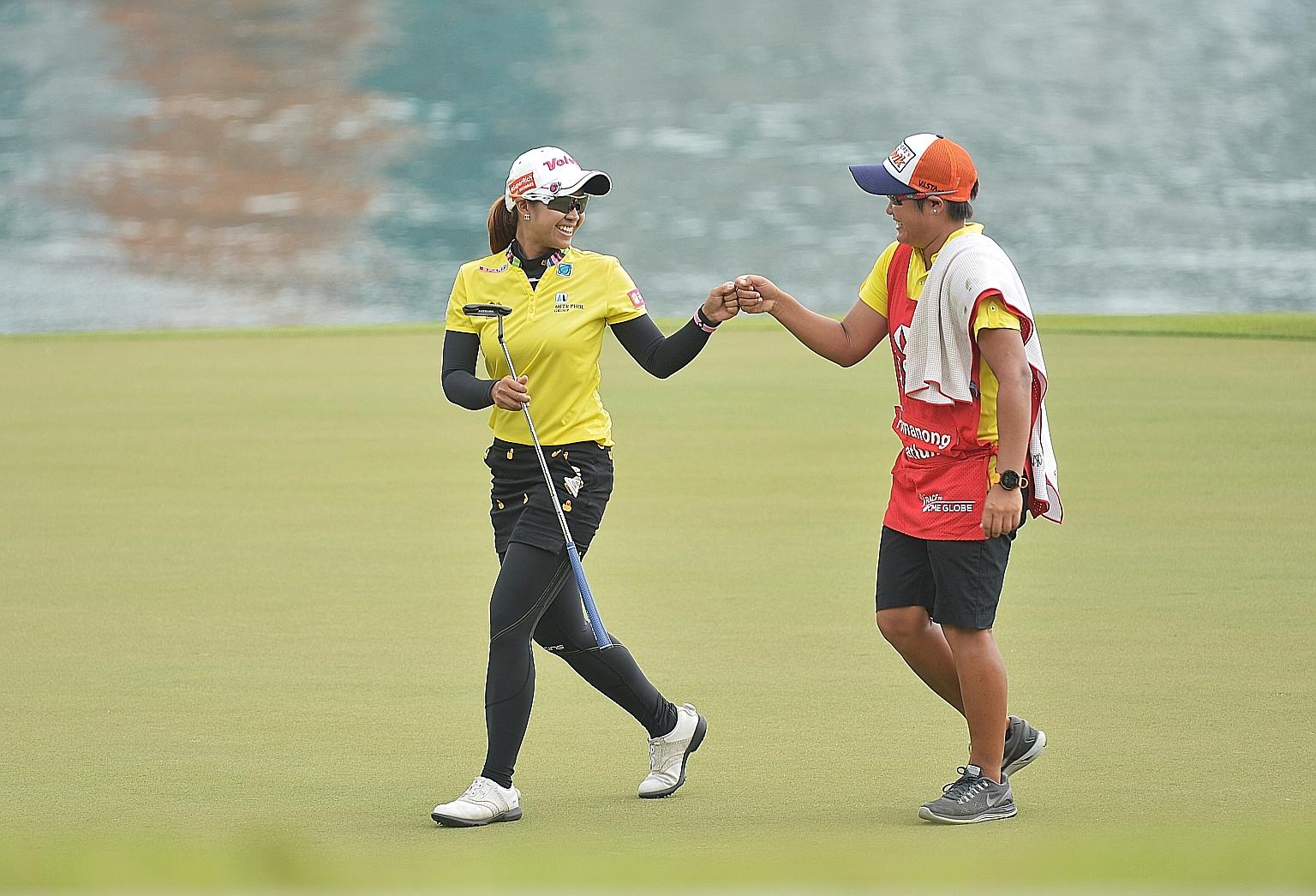 Thai golfer Pornanong Phatlum fist bumping her caddie at the 2016 HSBC Women's Champions in Singapore. LPGA players can opt to carry their own bags this season.
