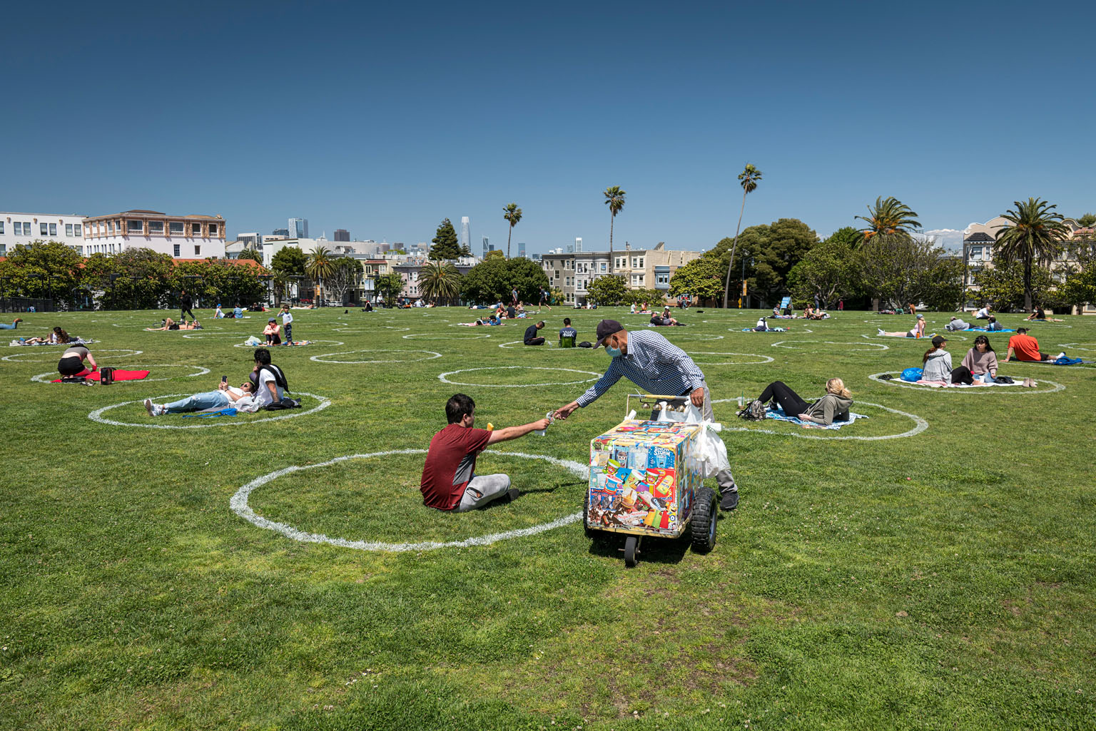 People relaxing within circles marked out on the grass to promote social distancing to curb the spread of the coronavirus in San Francisco, California, on Thursday.