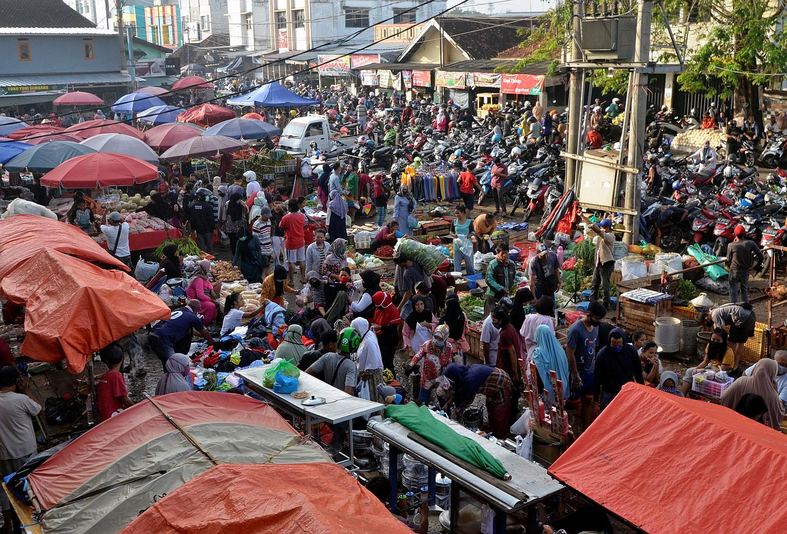Huge crowds at a traditional market in Bandar Lapmpung, Lampung province, yesterday, ahead of Aidilfitri celebrations, in this photo taken by Antara Foto. Widespread social distancing violations have generated angry responses from social media users