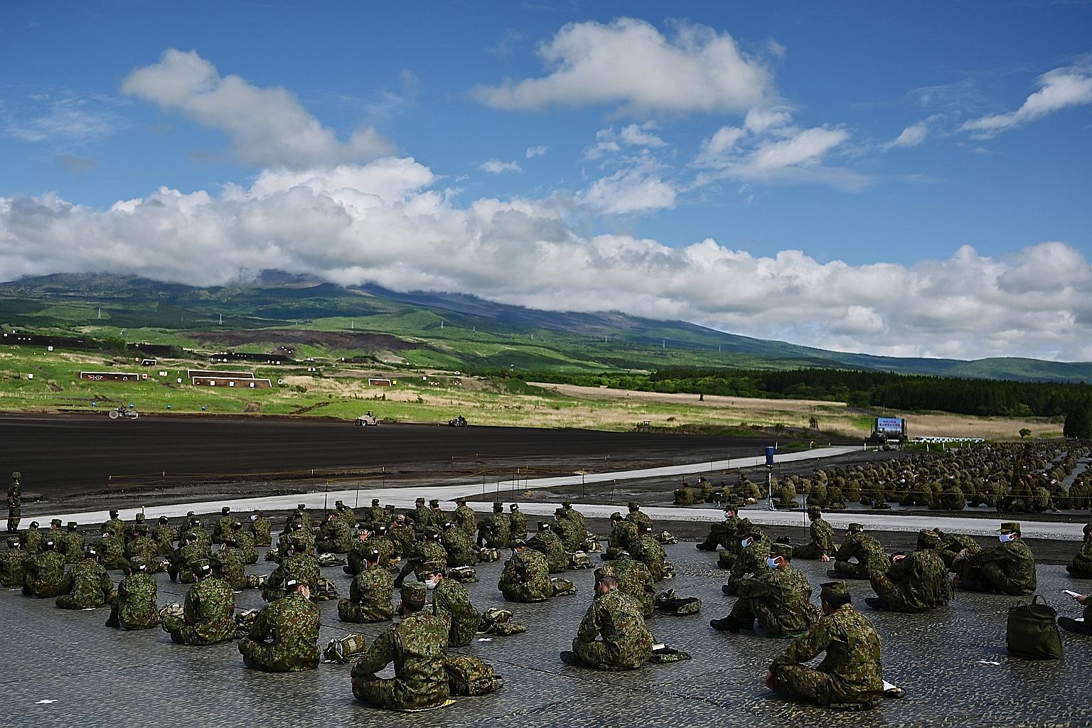Soldiers from the Japan Ground Self-Defence Force taking part in a live-firing exercise at the Higashi-Fuji firing range in Gotemba, Shizuoka prefecture, yesterday. Despite the coronavirus outbreak, Japan's defence forces have continued to conduct mi