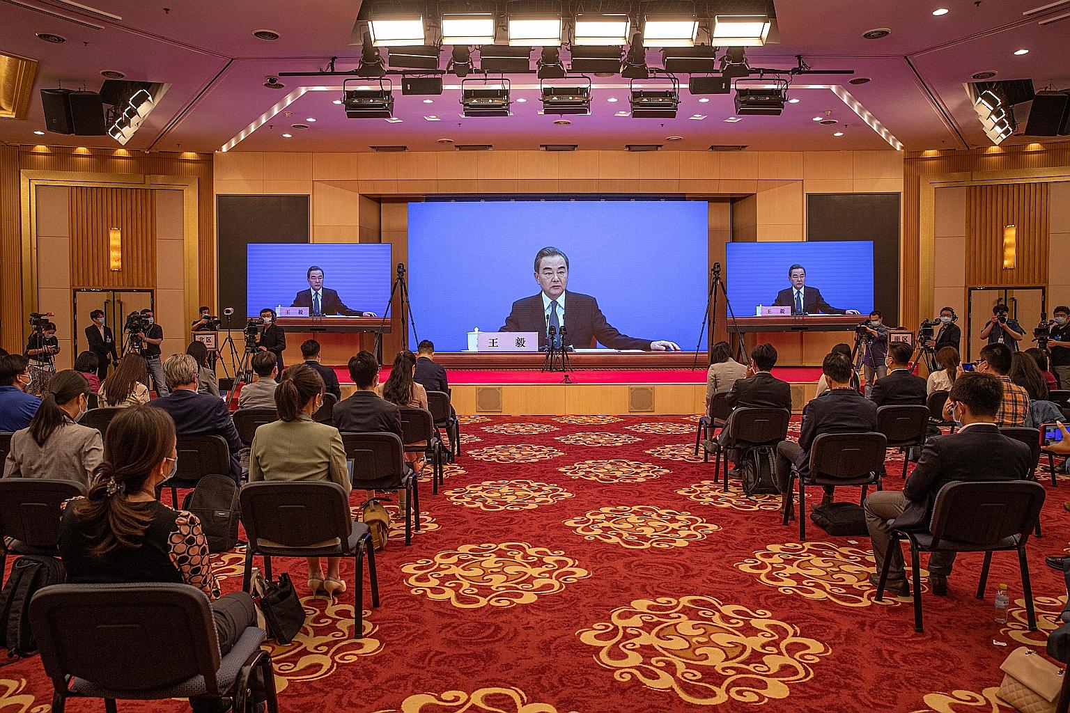 Chinese Foreign Minister Wang Yi speaking to reporters at a virtual briefing on the sidelines of China's legislative meetings in Beijing yesterday. Mr Wang said China has been working with Asean countries to beat the coronavirus, adding that ships an