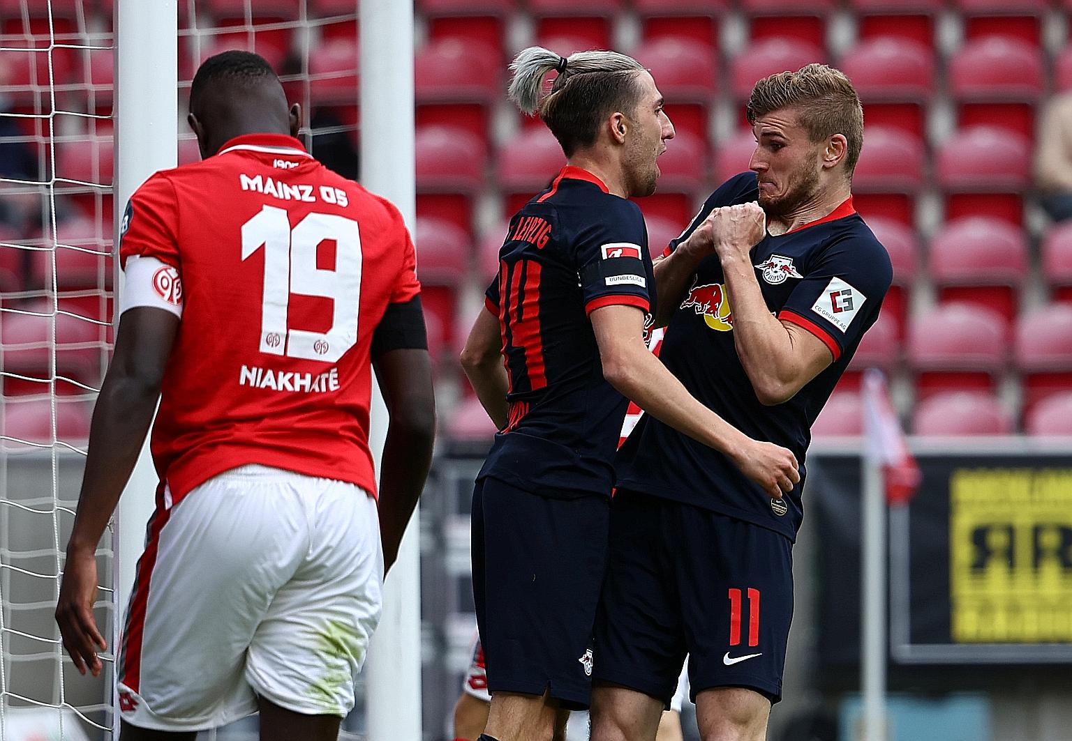 Leipzig's German forward Timo Werner (right) celebrating with teammate Kevin Kampl after scoring their fourth goal during the club's 5-0 win over Mainz yesterday.