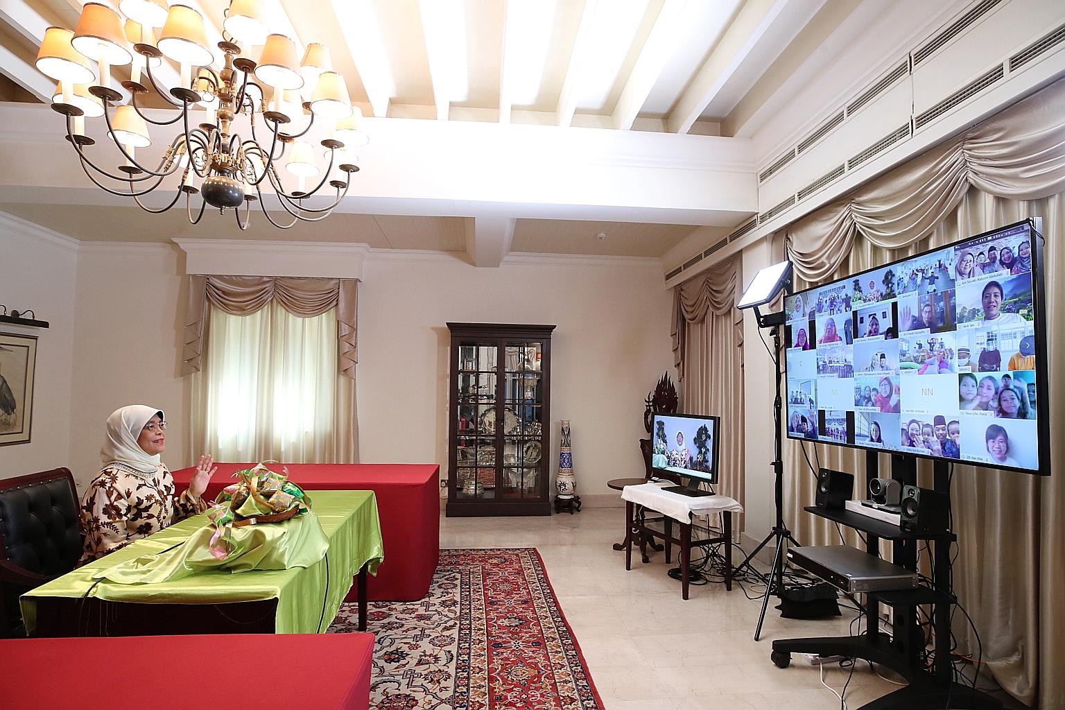 President Halimah Yacob chatting with participants via video conference during a virtual tour of the Istana for Hari Raya Aidilfitri celebrations. The virtual tour included 360-degree views of the reception hall, state room and banquet hall inside th