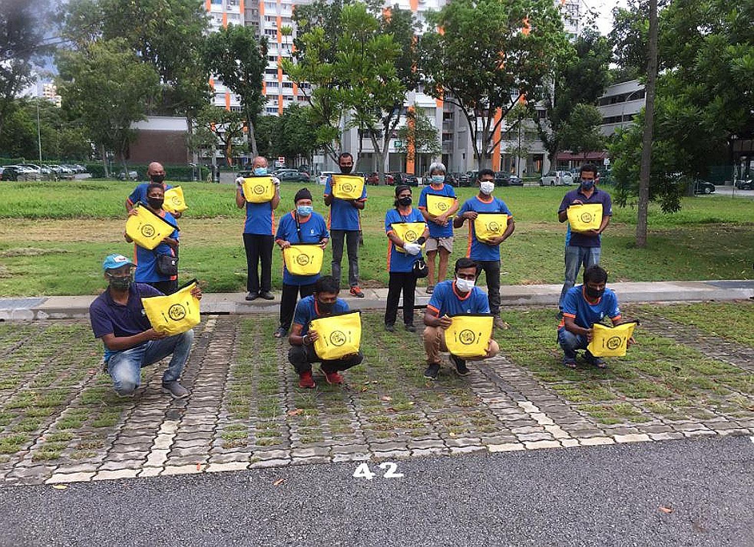 Cleaners from Bishan-Toa Payoh GRC with their Raya Kindness Packs. The packs, containing items like festive cookies and a thermal bag, were also given to cleaners in Tanjong Pagar GRC and Jalan Besar GRC.