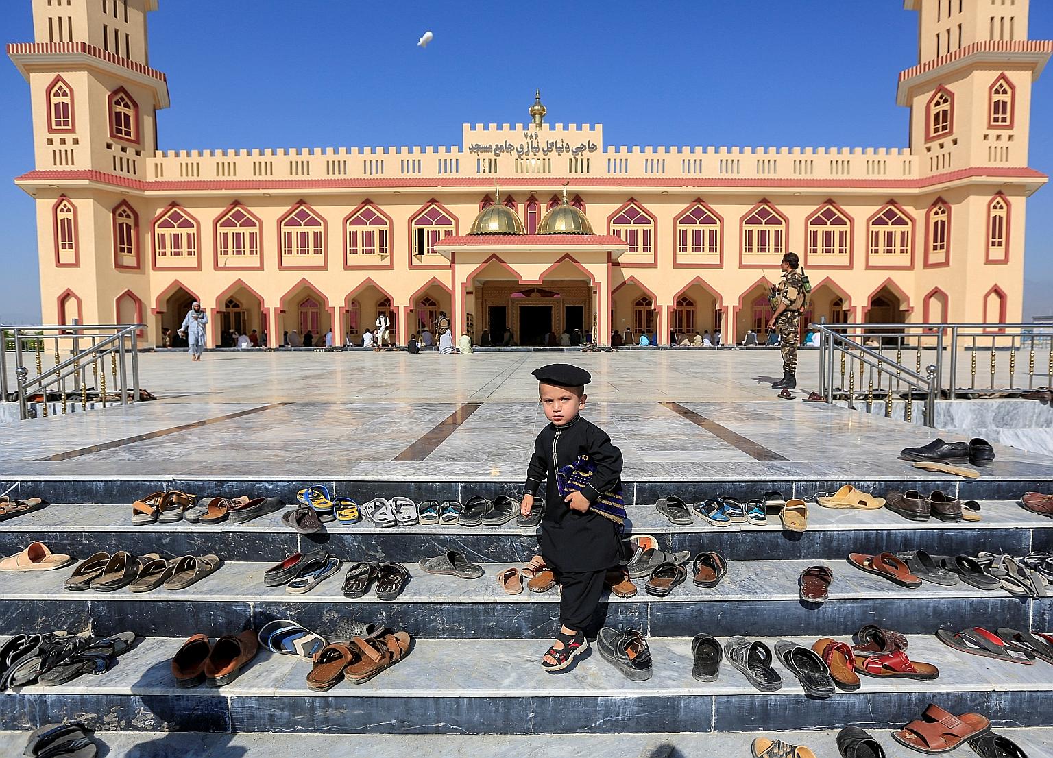 An Afghan boy outside a mosque during the Eid al-Fitr holiday in Laghman province, Afghanistan, yesterday. The Taleban made a three-day truce offer that started on Sunday to mark the holiday - a move swiftly welcomed by the Afghan government.