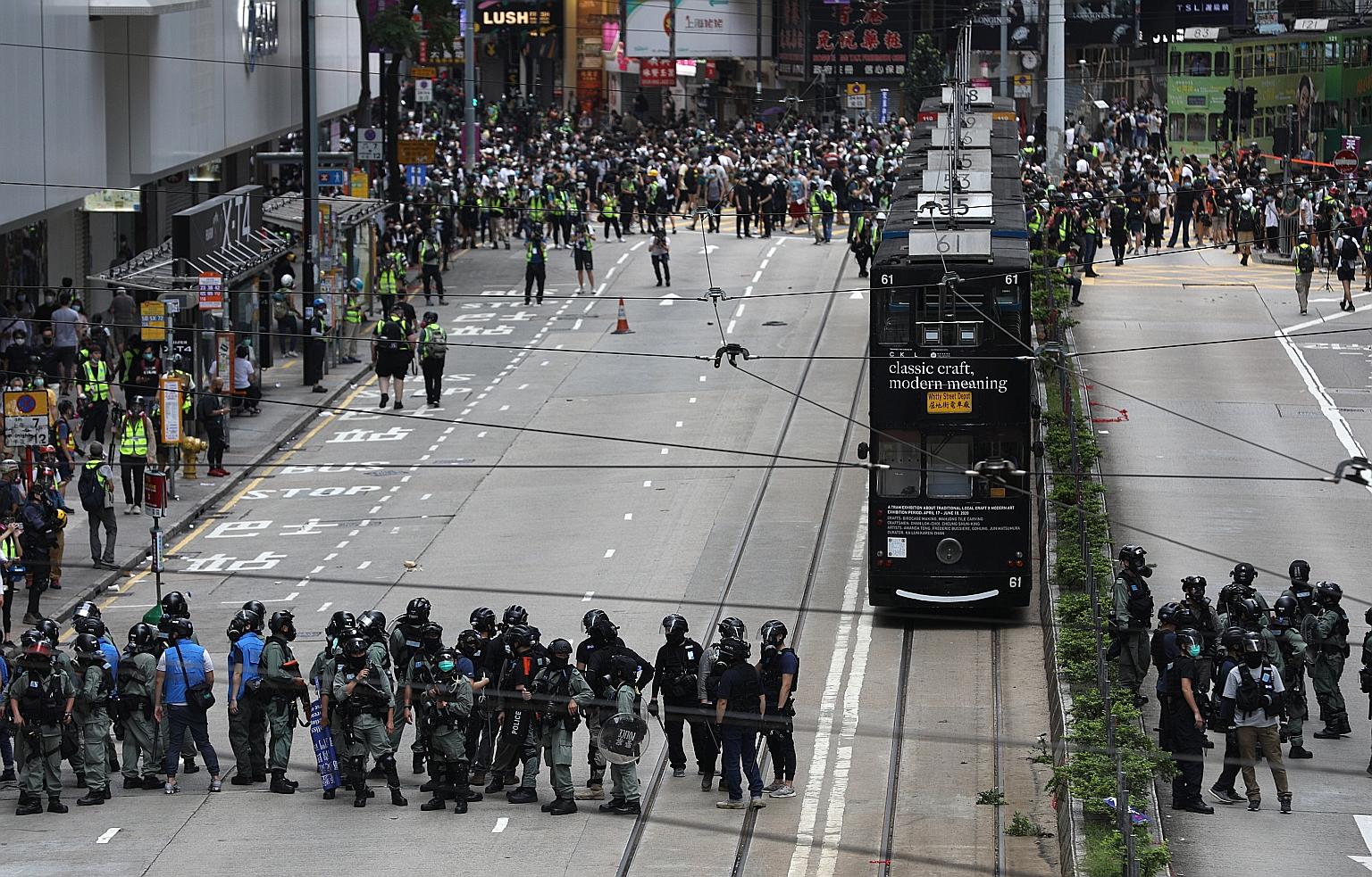 Protesters in a stand-off with riot police in Causeway Bay, Hong Kong, on Sunday. They were rallying against a proposed national security law that pro-democracy activists fear will limit rights and freedoms in the city, but which the Chinese governme