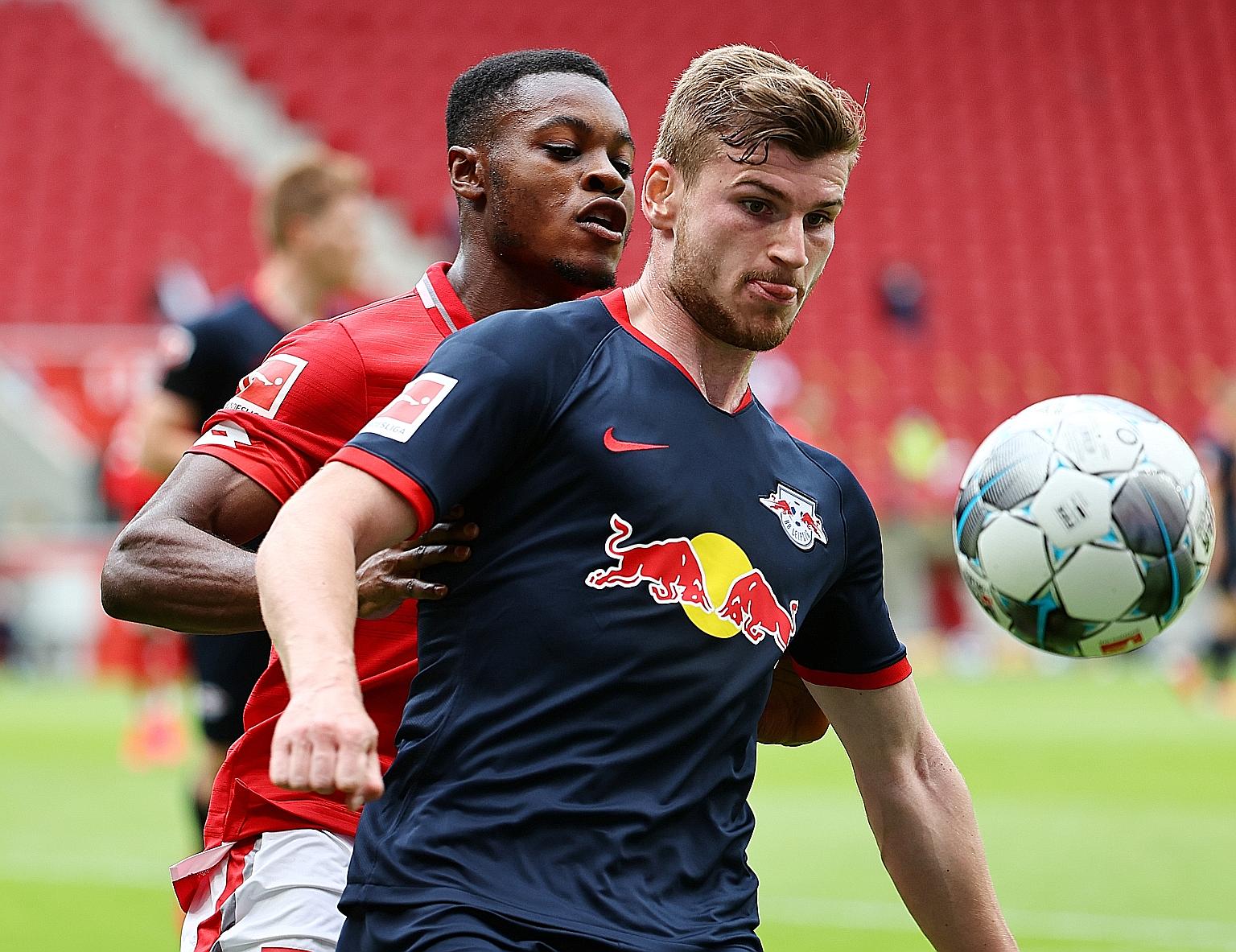 Leipzig's Timo Werner, getting some close attention from his Mainz marker Bote Baku during their match on Sunday. The Germany international netted a hat-trick in the 5-0 win to take his season's league tally to 24.