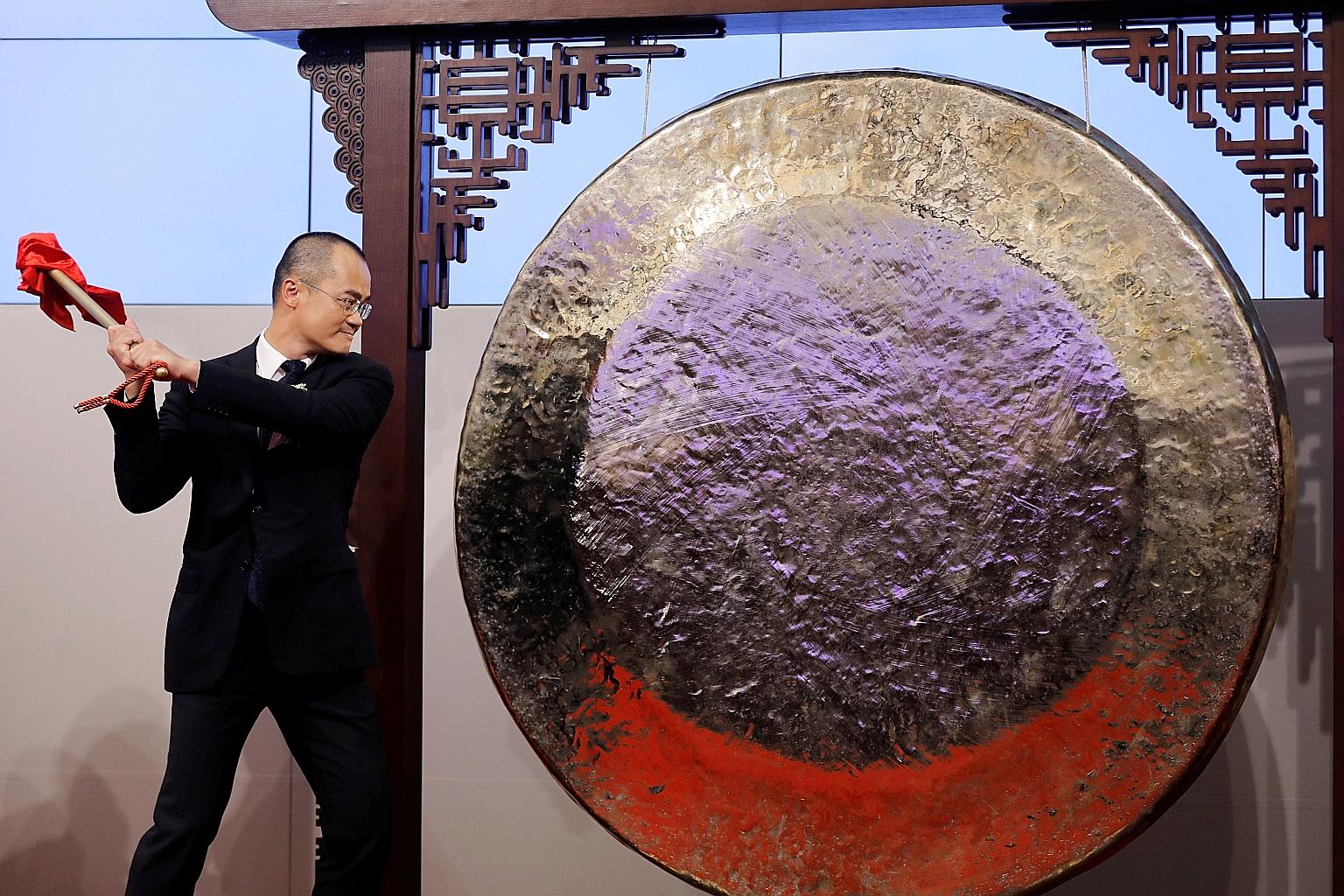 Mr Wang Xing, founder and CEO of Meituan Dianping, striking a gong during the company's debut in Hong Kong in September 2018. Meituan's stock rose 10.4 per cent on Tuesday after it reported better-than-expected revenue, driving its market value past