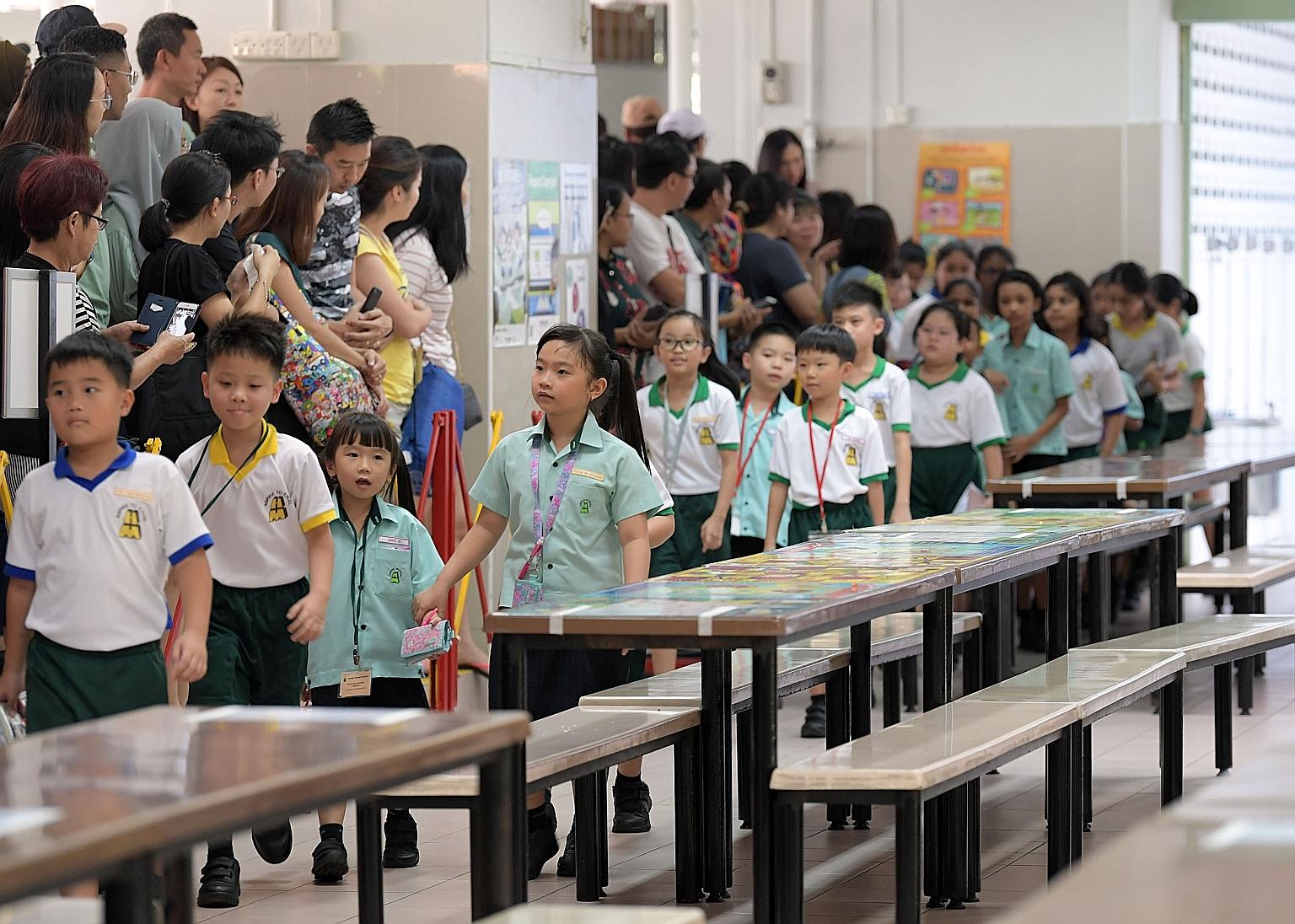 Pupils on their first day at Huamin Primary School last year. Registration for children starting Primary 1 next year will have to be done online and the exercise runs from July 1 to Oct 30 in seven phases. Phases 1, 2C and 2C Supplementary are alread