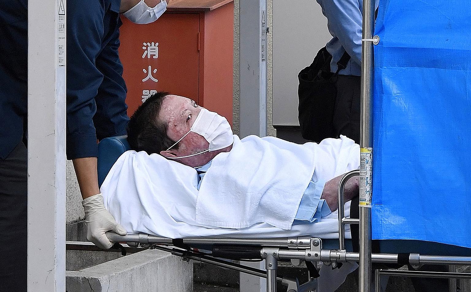 Suspect Shinji Aoba being taken to a police station in Kyoto yesterday, following his formal arrest over a fire that killed 36 people in the Japanese city last year. He could not be questioned earlier because he had suffered serious burns in the blaz