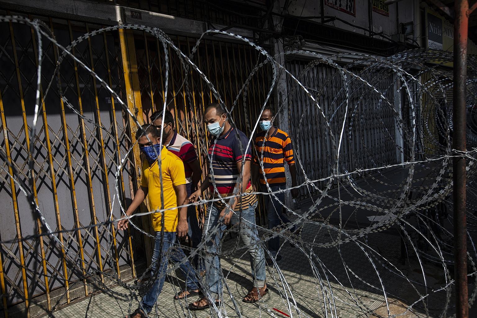 Migrant workers in a locked down area in Kuala Lumpur this month. Such workers in Malaysia are a risk group for Covid-19 infection.