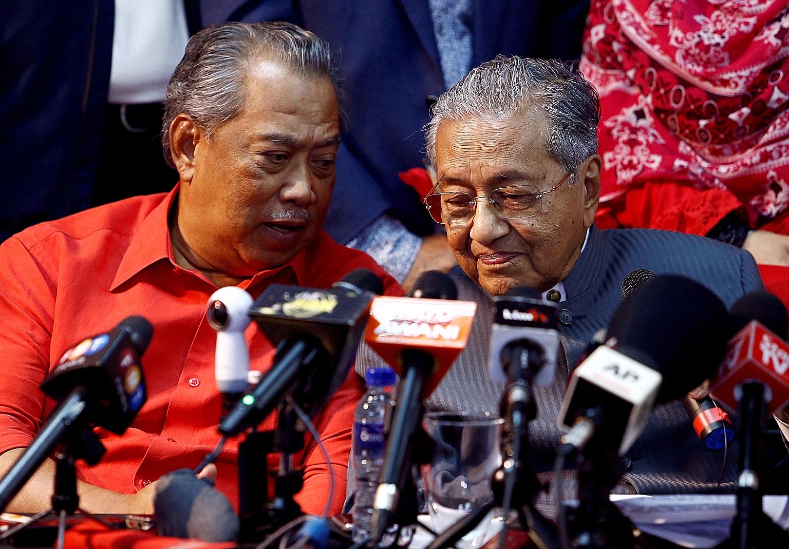 In a file photo from 2018, Tan Sri Muhyiddin Yassin (left) and Tun Dr Mahathir Mohamad are seen at a news conference. Dr Mahathir has been ejected from the party he co-founded, along with four other lawmakers who have refused to support the governmen