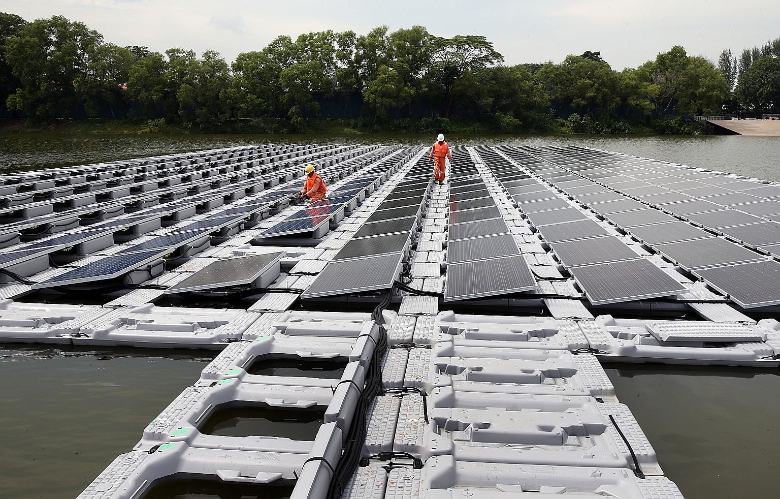 A 2016 photo showing a floating solar photo-voltaic cell test-bed in Tengeh Reservoir in Tuas. Singapore has pledged to peak emissions at 65 million tonnes of carbon dioxide equivalent around 2030.