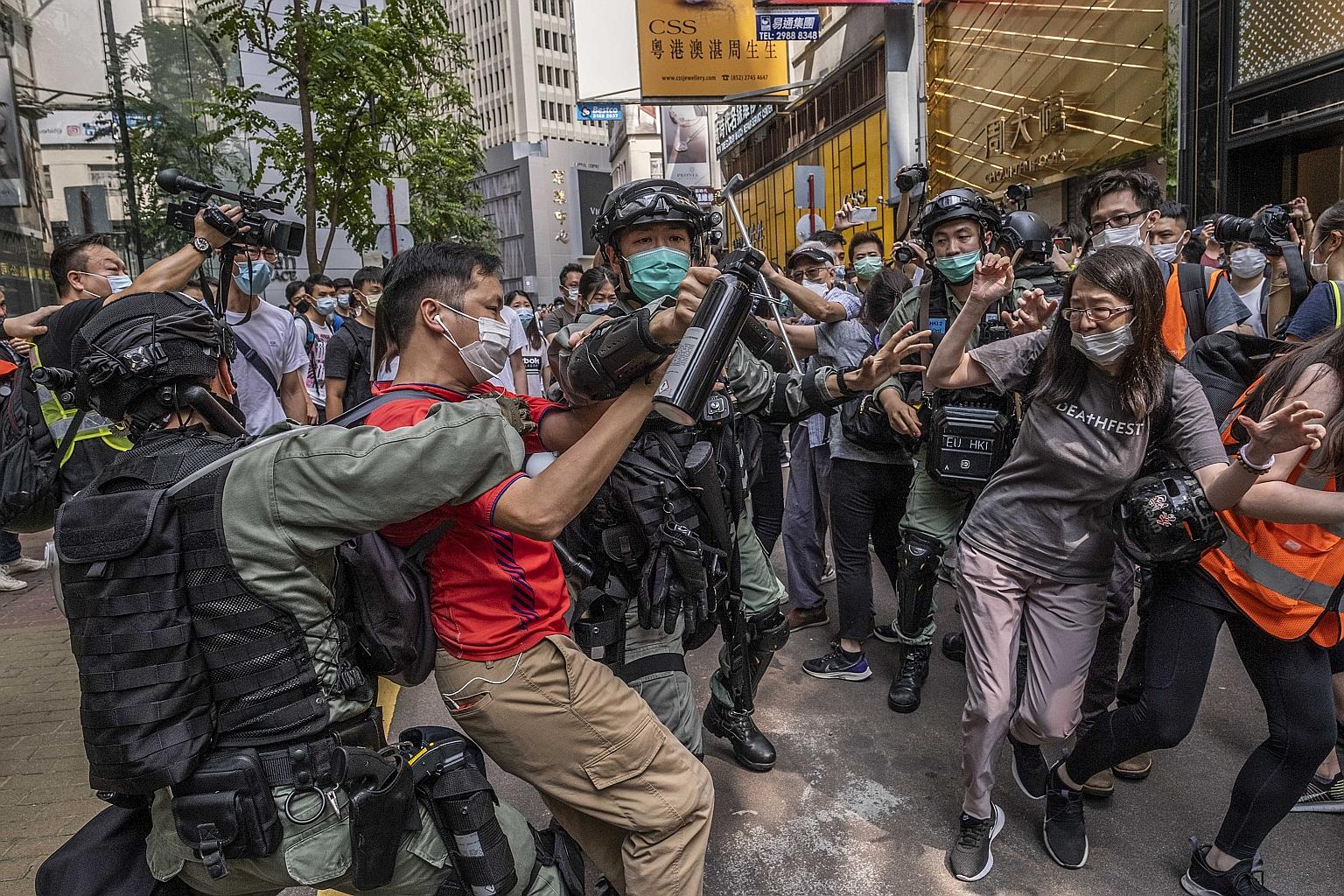 Protesters clashing with riot police officers in Hong Kong last Wednesday. The city is bracing itself for more demonstrations in the coming weeks against Beijing's planned national security legislation for Hong Kong, and the United States has said it