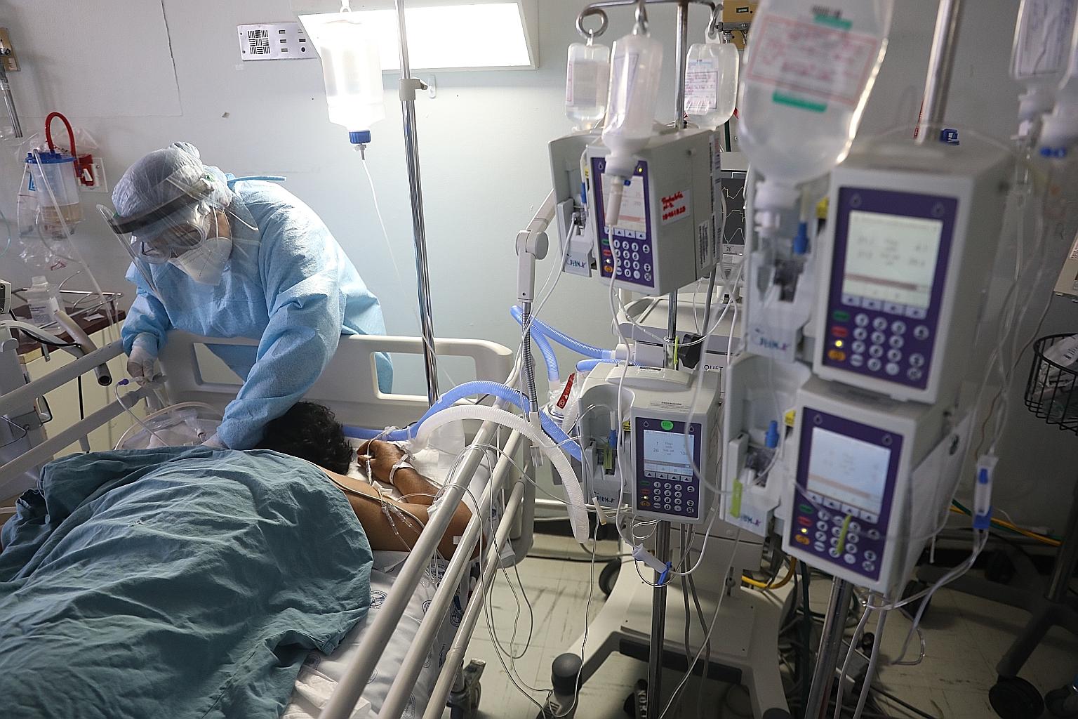 A health worker treating a coronavirus patient attached to a life support machine at the Hospital Juarez in Mexico City. About one in five confirmed cases in Mexico is a health worker.
