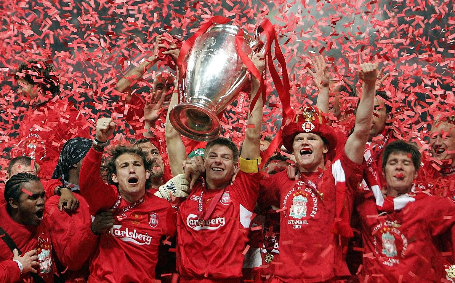 Liverpool's captain Steven Gerrard (holding the trophy) and his jubilant teammates on May 25, 2005, at the end of the Uefa Champions League football final at the Ataturk Stadium in Istanbul, where Liverpool beat AC Milan in dramatic fashion. Reunited