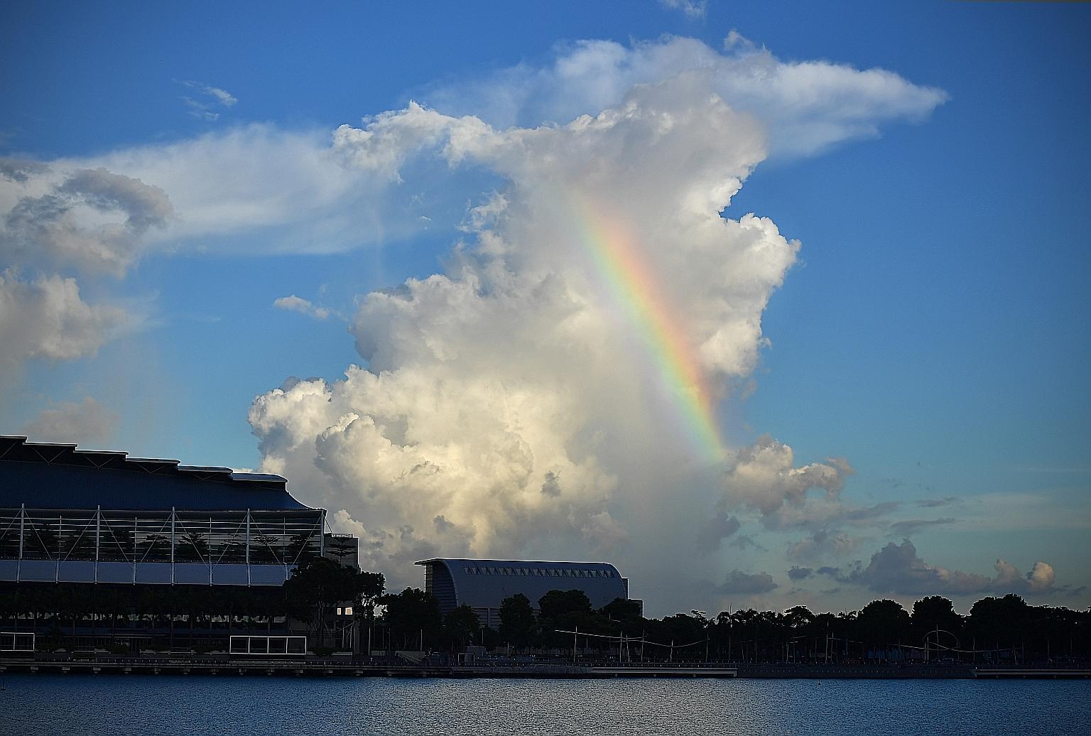 A rainbow is seen in the skies above the Marina Bay Sands area on Saturday. Fewer cars on the road and a drop in air travel, as well as more people working from home instead of commuting to the office, has resulted in clearer skies in many cities.