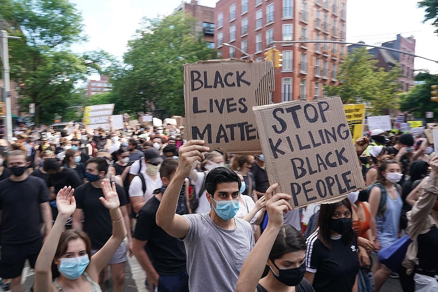 Demonstrators marching in New York City on Saturday as protests continued across the United States over the death of Mr George Floyd in Minneapolis, Minnesota. The African-American man was shown on video pleading that he could not breathe as a white 
